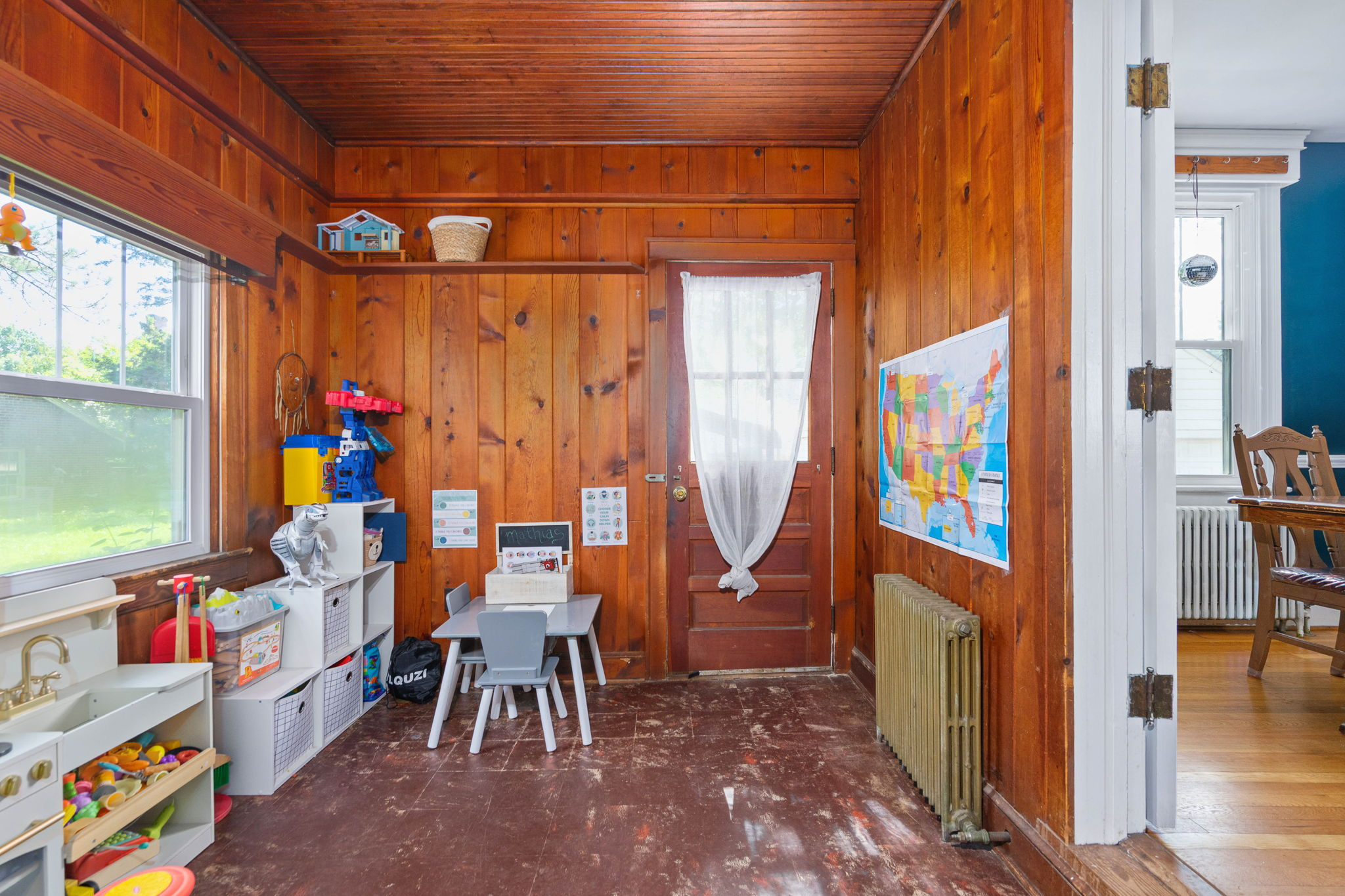 Wood-paneled flex room with mid-century charm