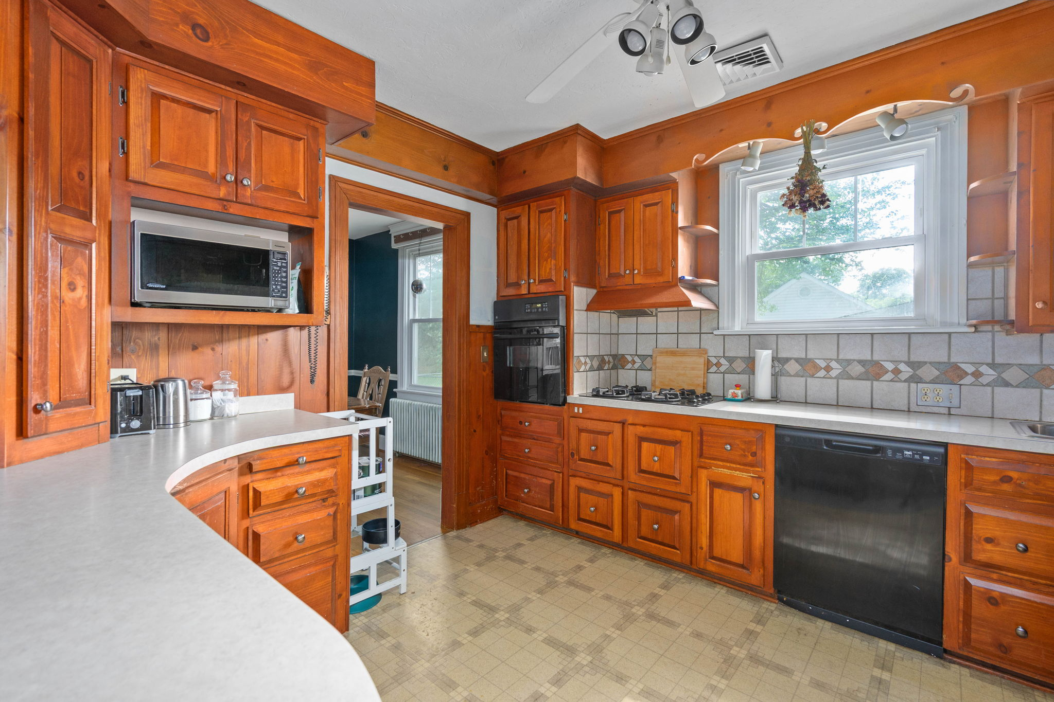 Kitchen with custom wood cabinetry and tiled backsplash