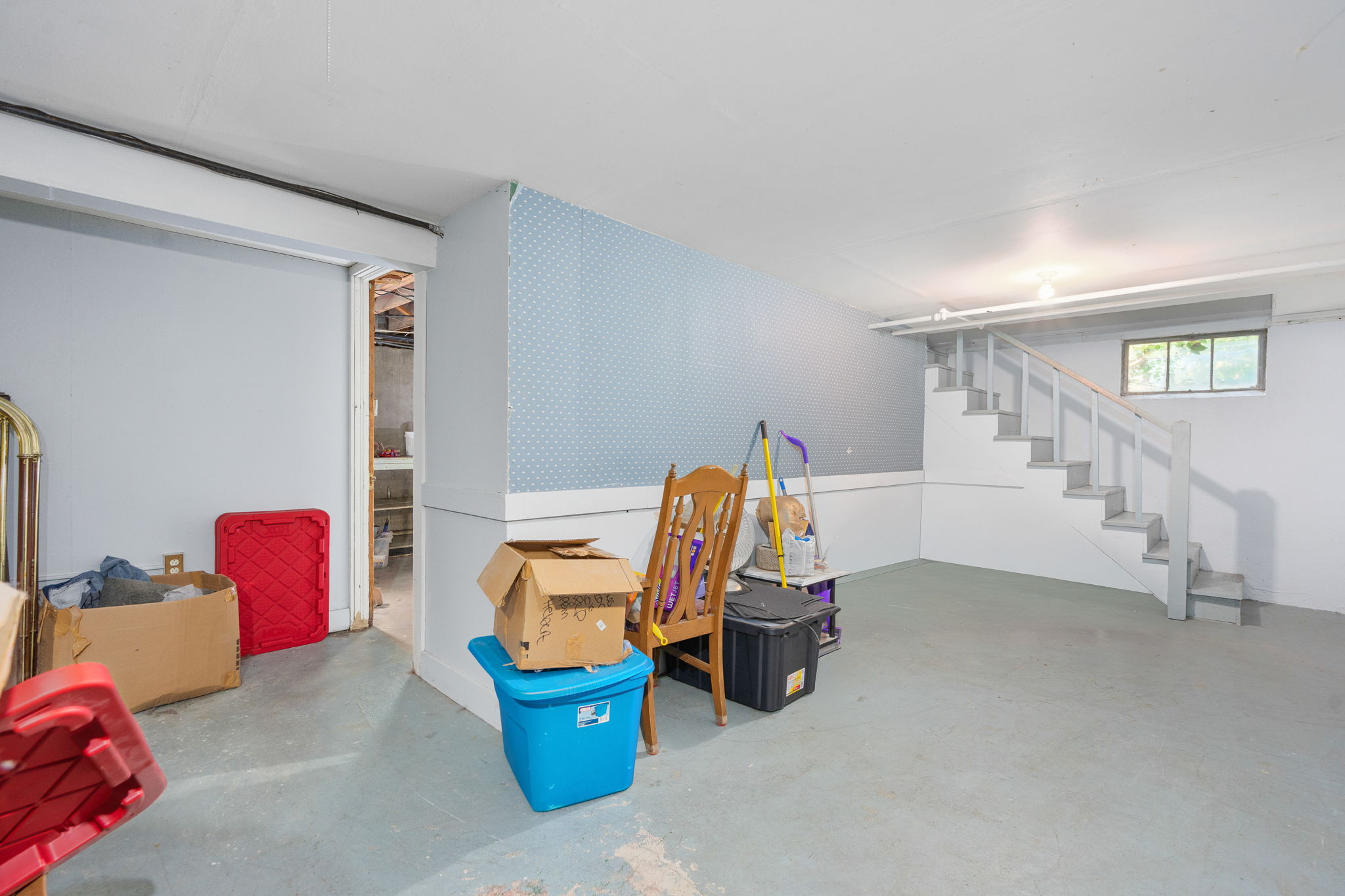 Basement recreation room with painted concrete floors