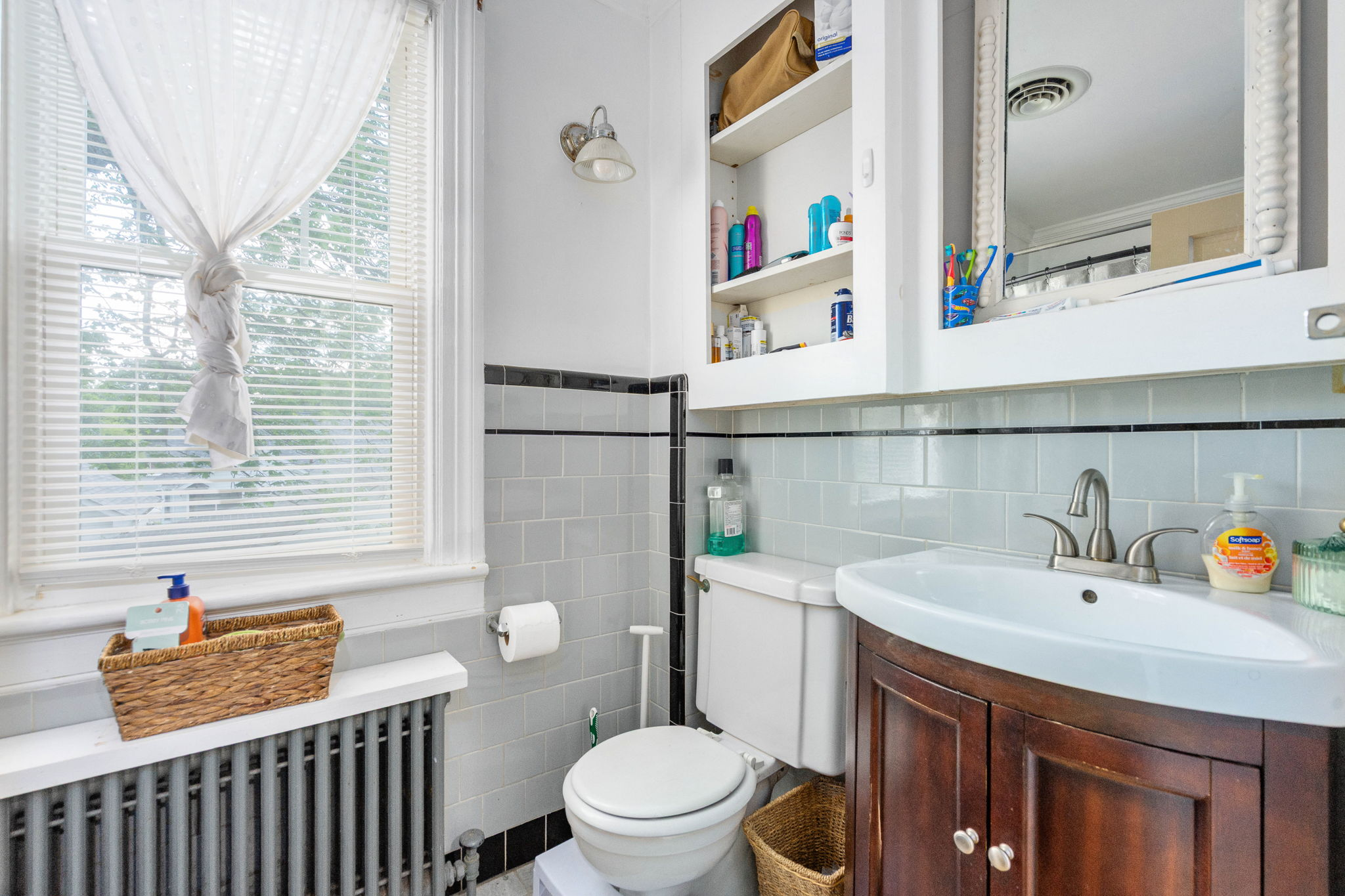 Retro tiled bathroom with gray square tiles and black accent trim