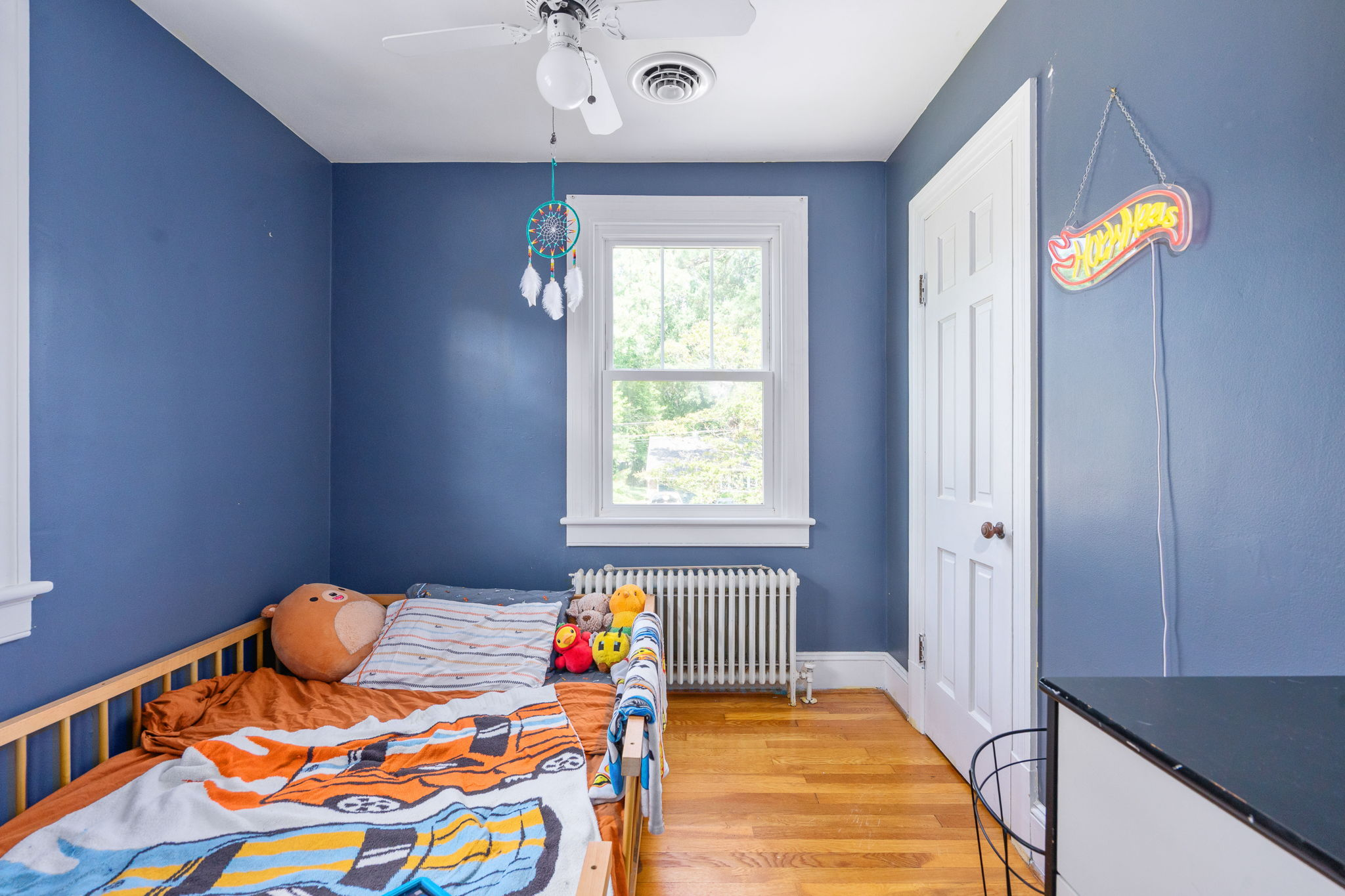 Bedroom with blue walls and original hardwood floors