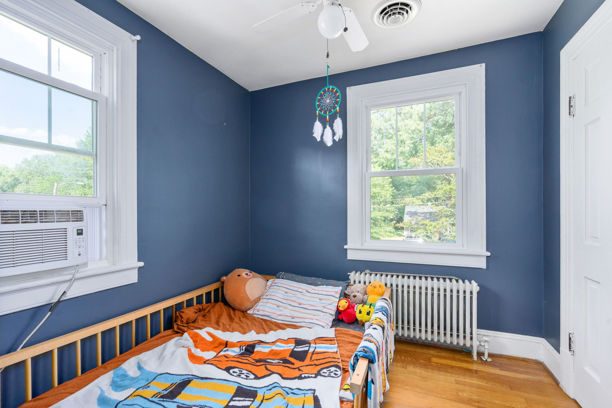 Bedroom with blue painted walls and white trim