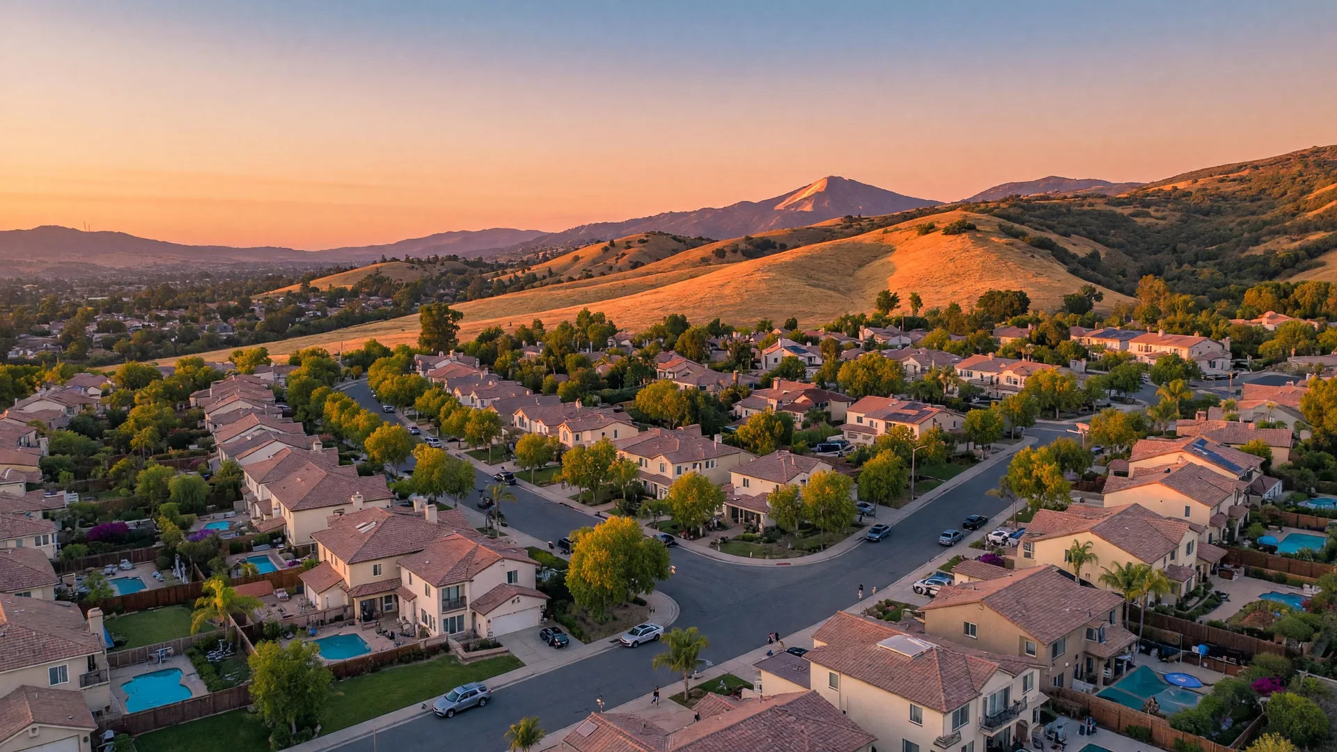 Aerial view of Santa Clarita Valley neighborhoods with golden hills in the background