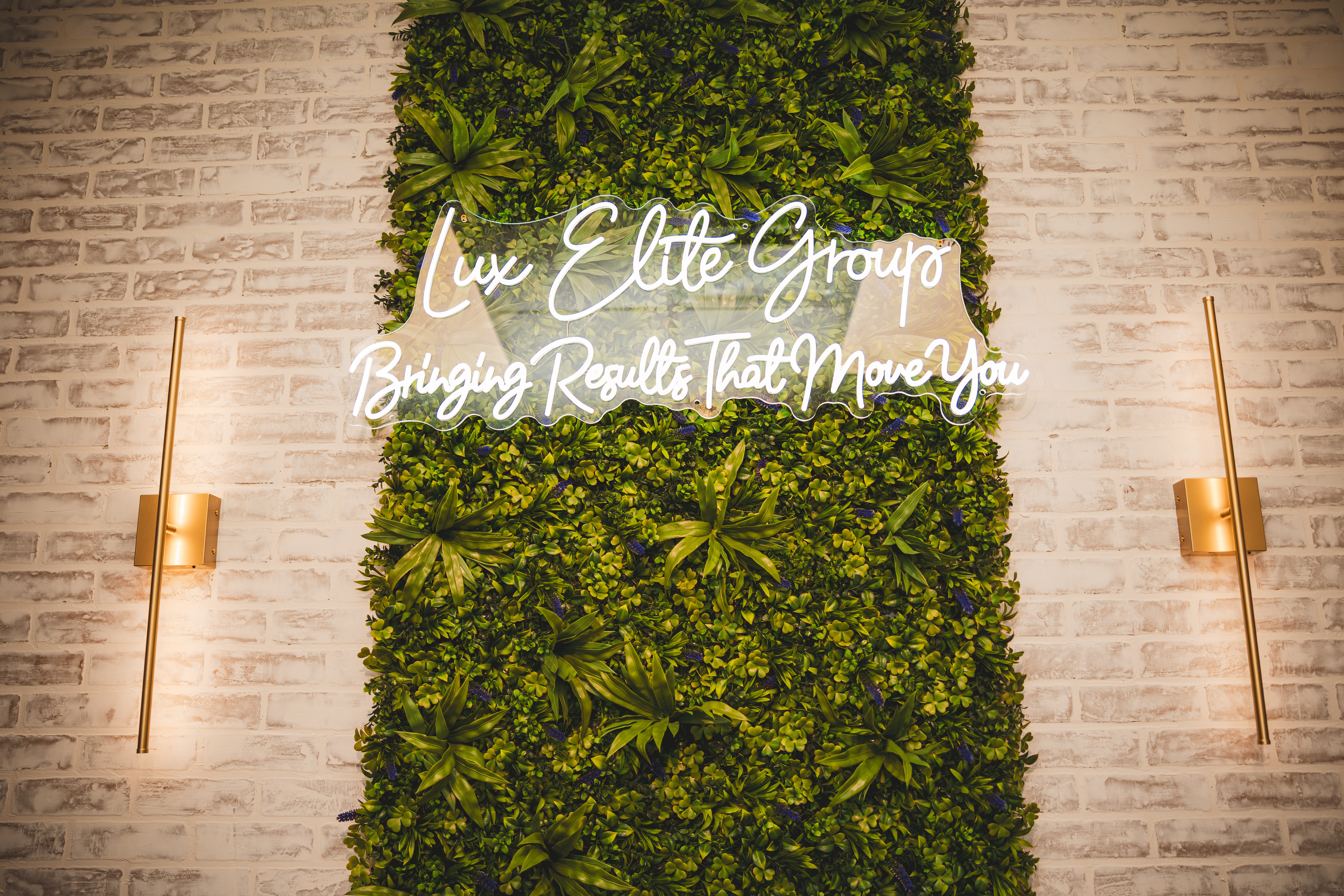 Neon sign backdrop inside the Glasshouse Realty office