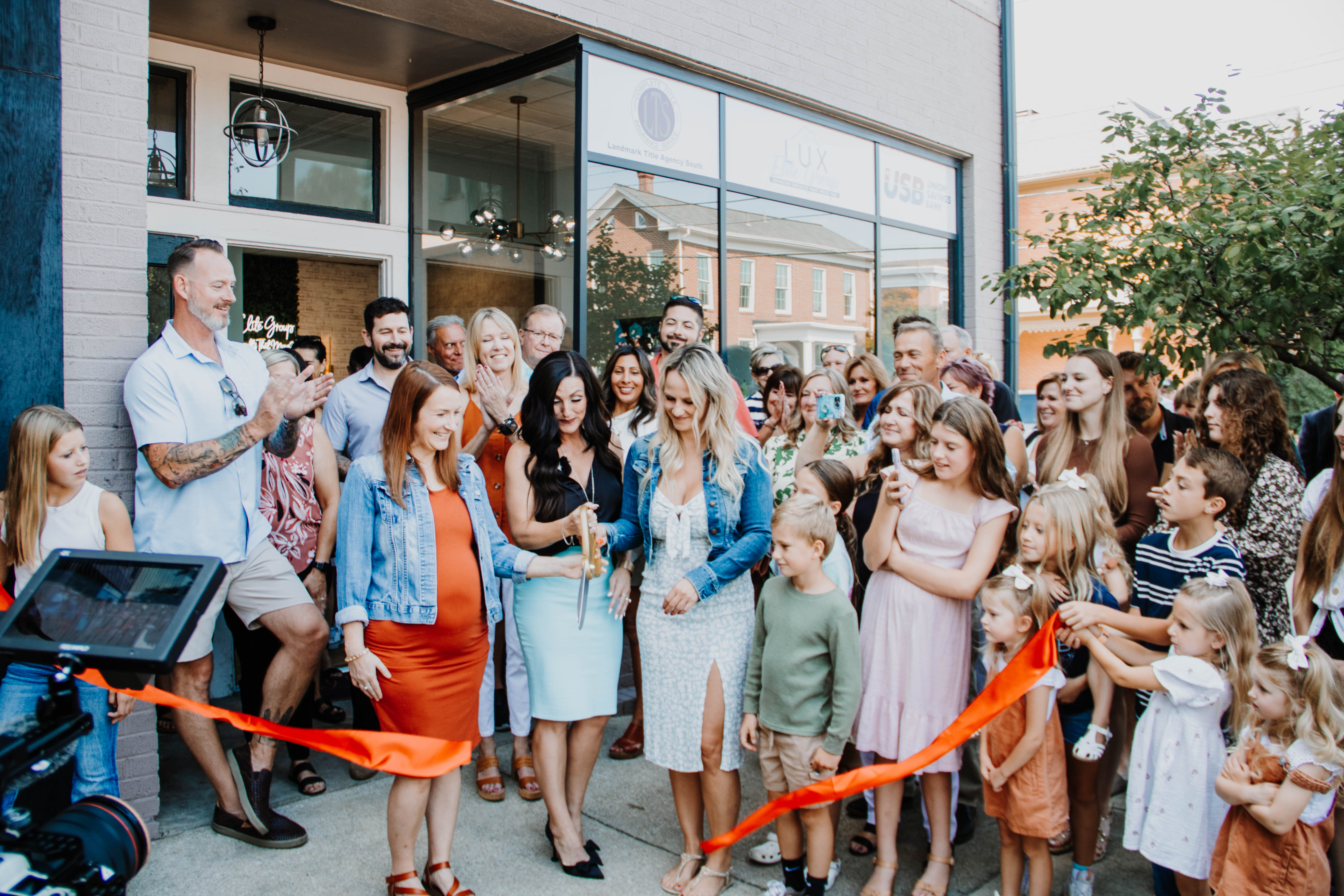 Community ribbon cutting ceremony at a Glasshouse Realty Group office opening event in Wilmington, Ohio