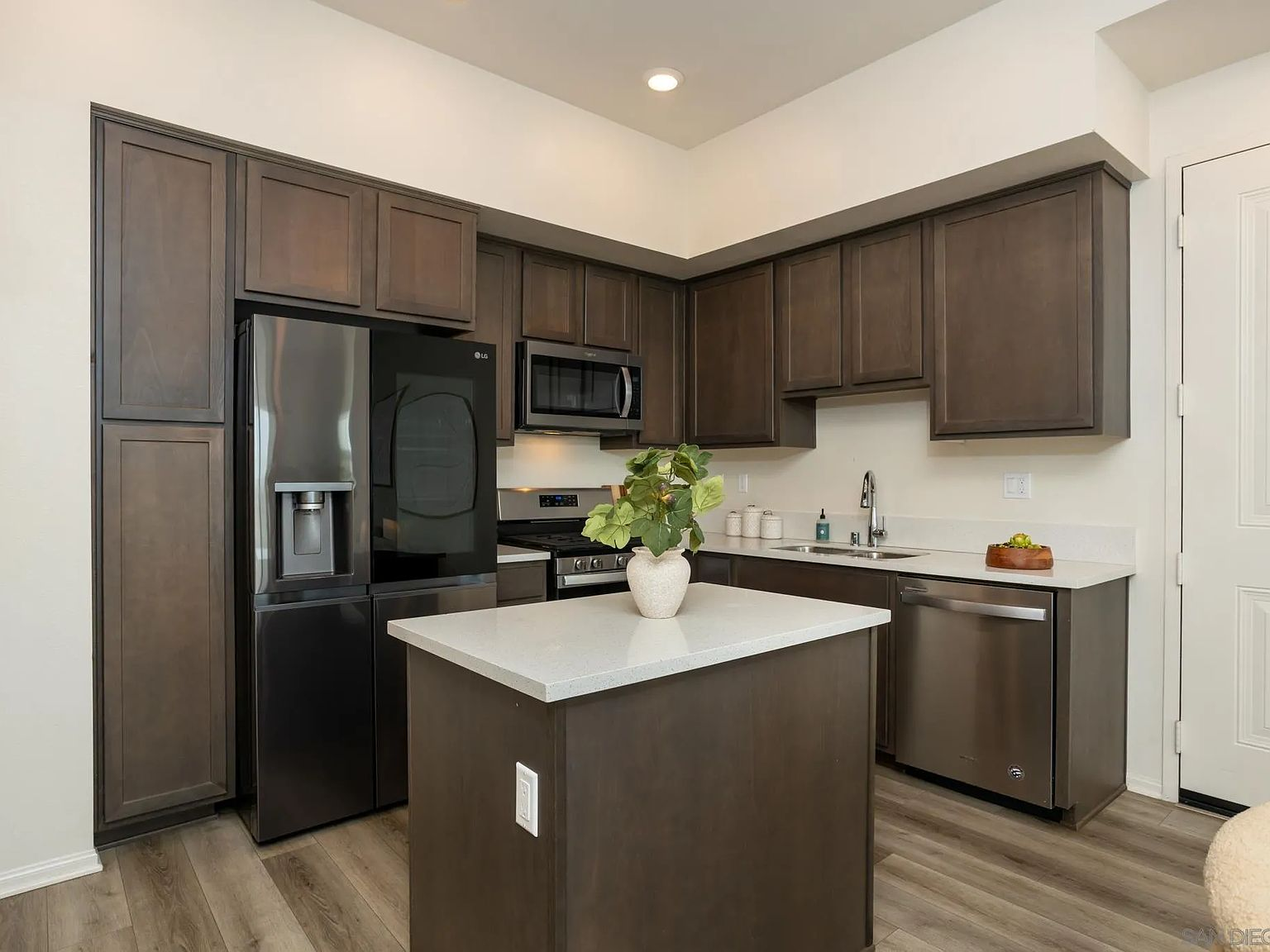 Modern kitchen with dark cabinets and quartz countertops