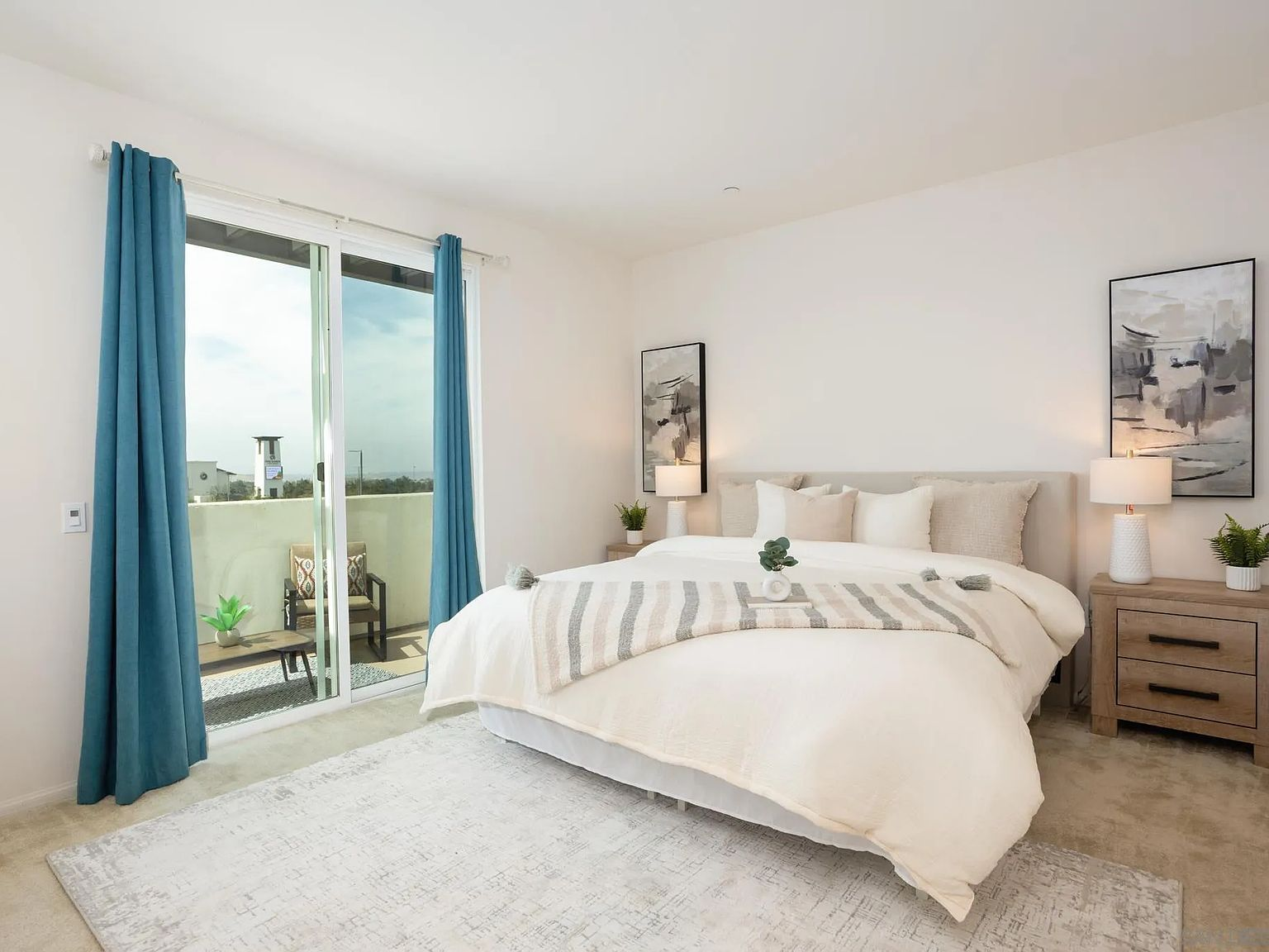 Primary bedroom with balcony access and natural light
