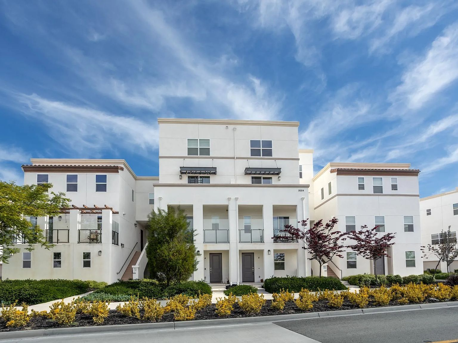 Townhome facade with glass balcony railings