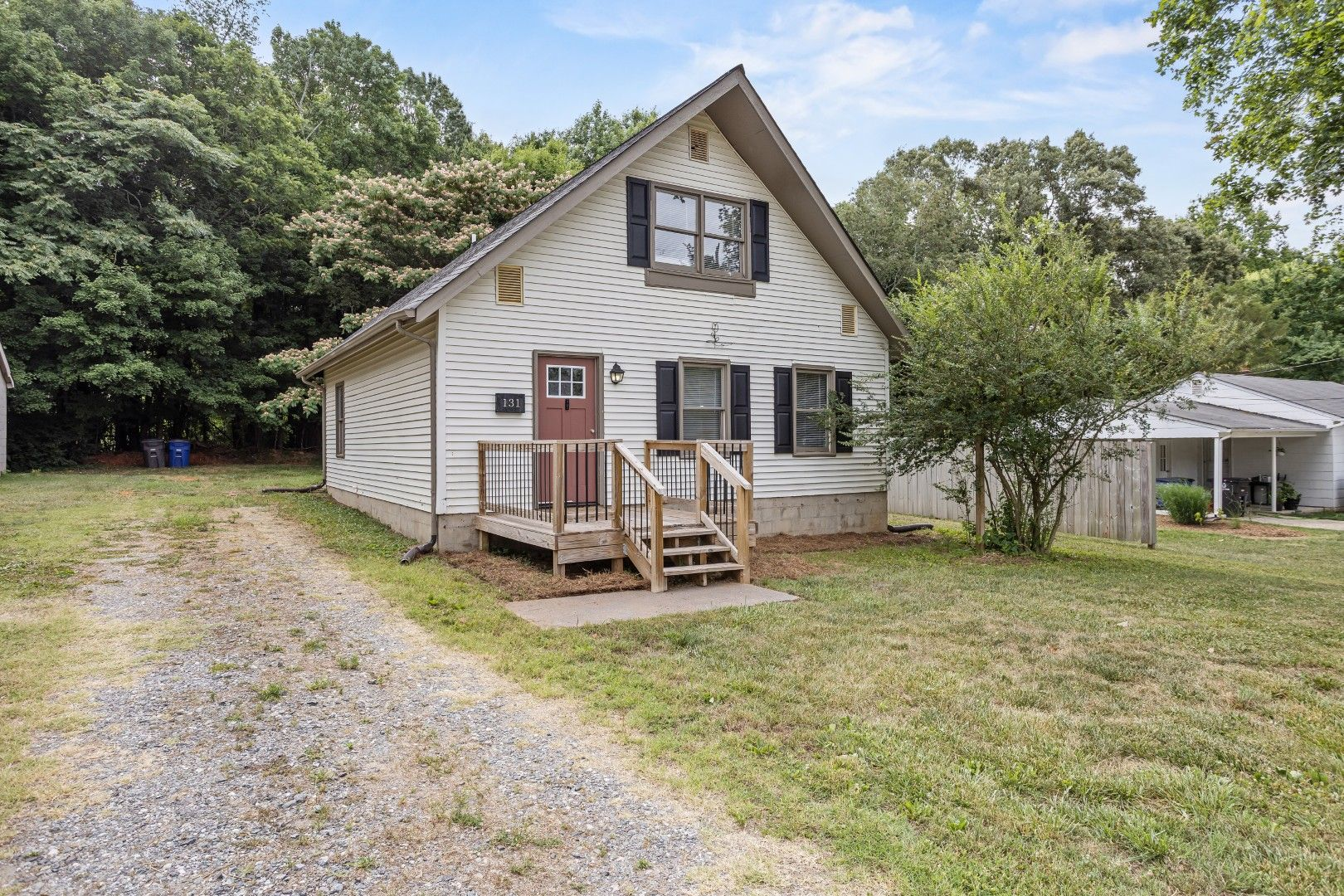 Full front facade with new porch deck and modern railing