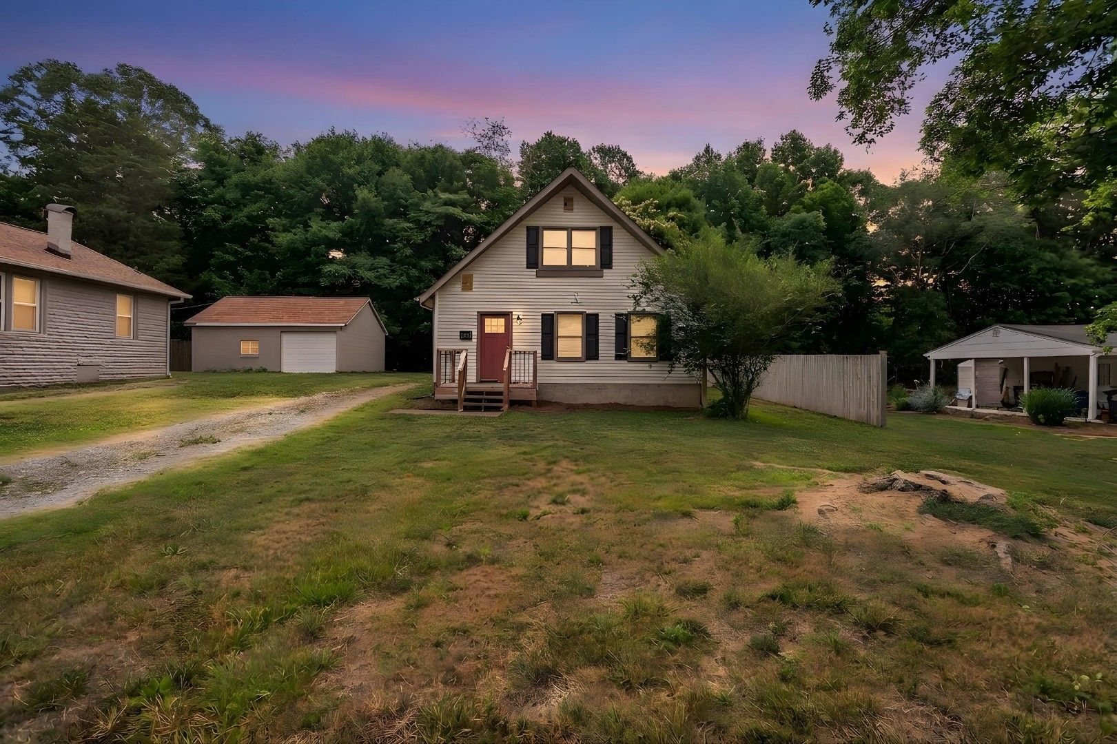 Front exterior of 131 Lindbergh Street, Winston-Salem — a traditional home with white siding, black shutters, and updated front deck