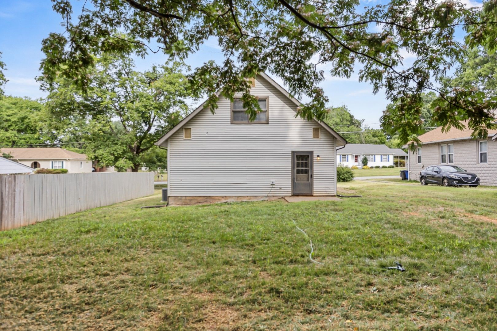 Backyard view showing rear of home and yard space