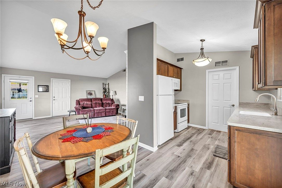 Open-concept kitchen and dining area with traditional cabinetry