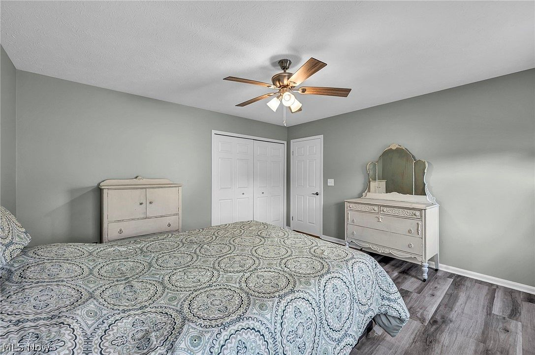 Bedroom with modern gray paint and wood-plank flooring
