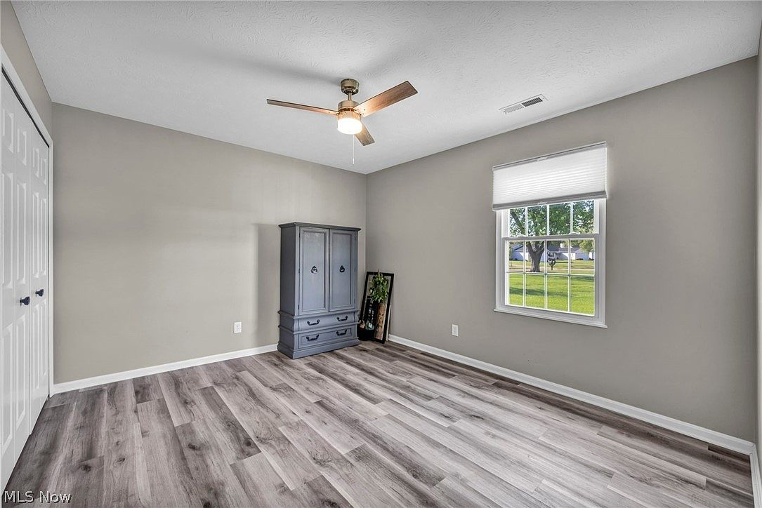 Bedroom with neutral grey paint and white trim