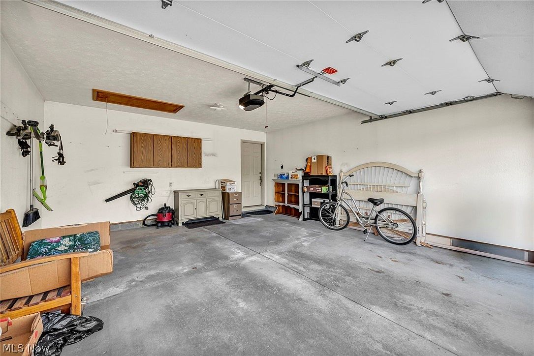 Attached two-car garage with concrete flooring