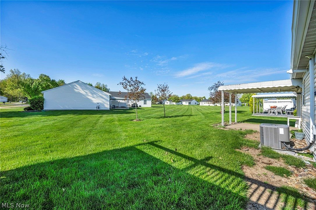 Backyard view from the side of the house with patio cover