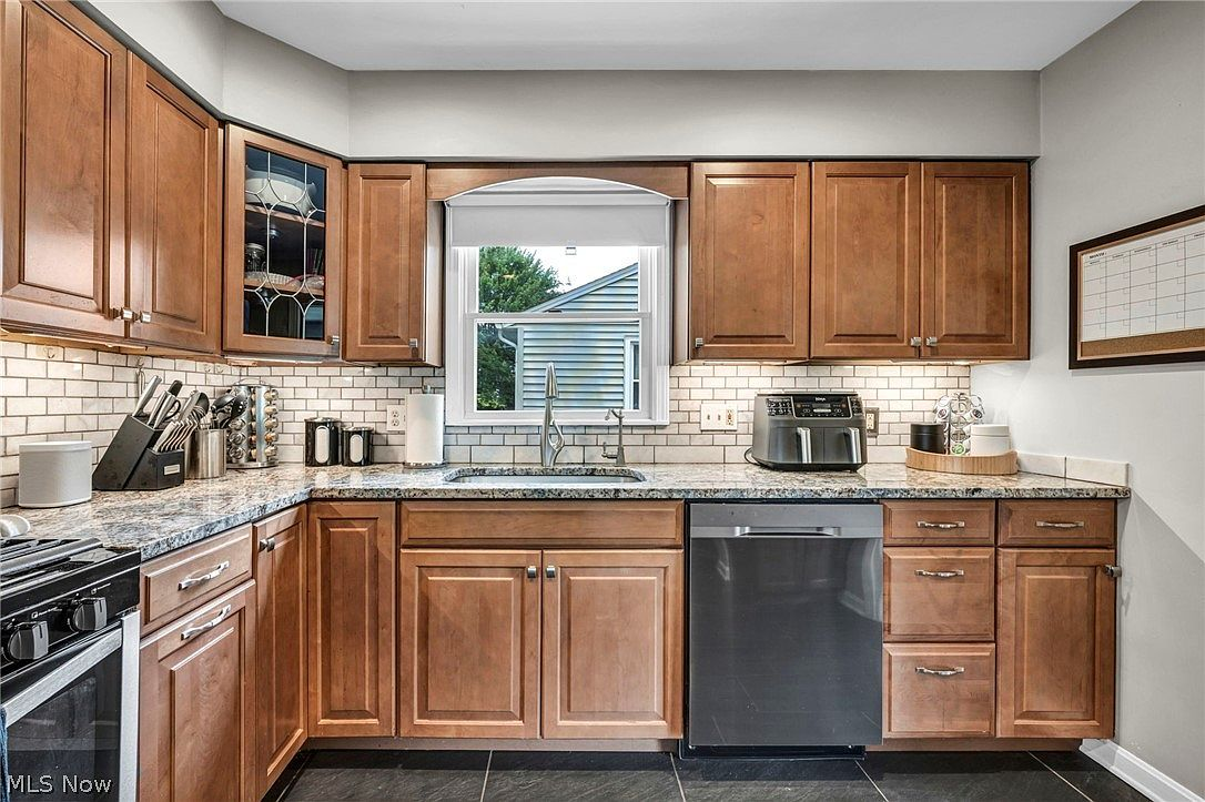 Remodeled kitchen with granite countertops and oak cabinetry