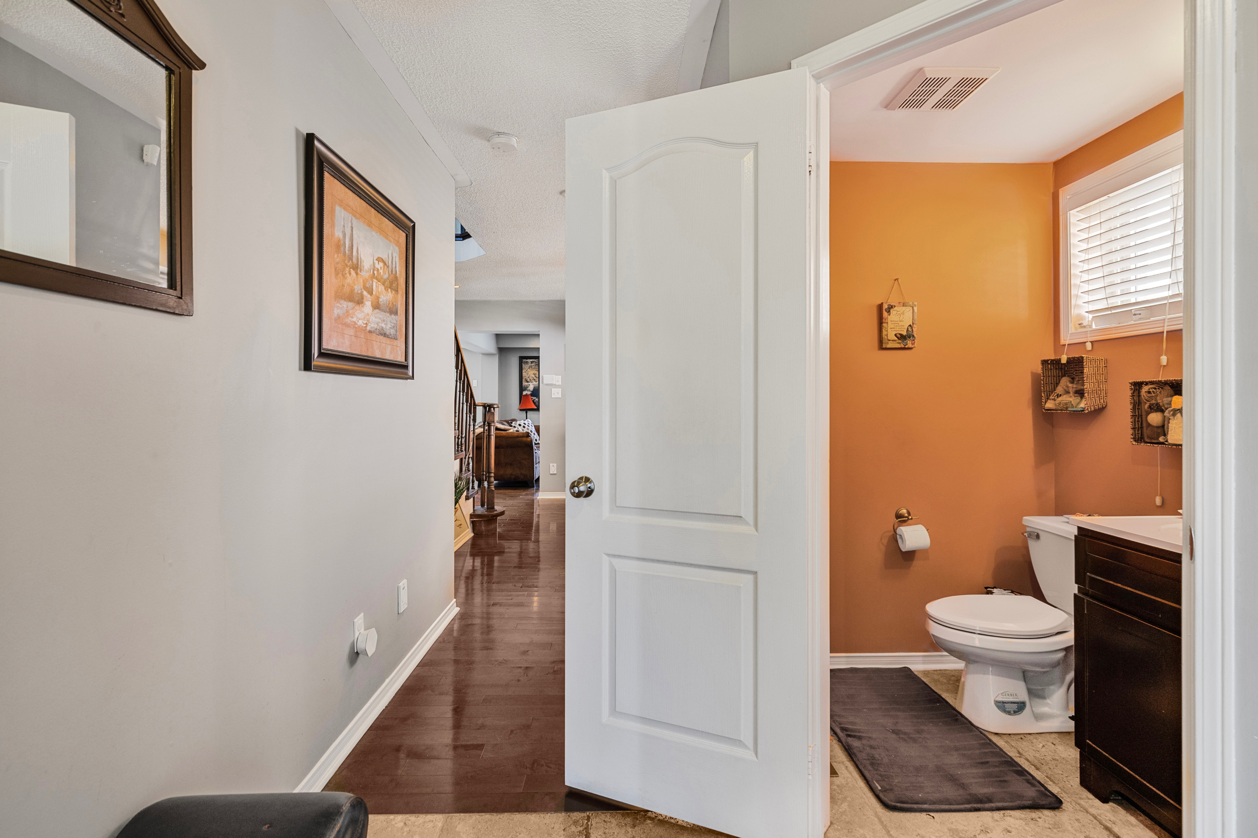 Main floor powder room with orange walls