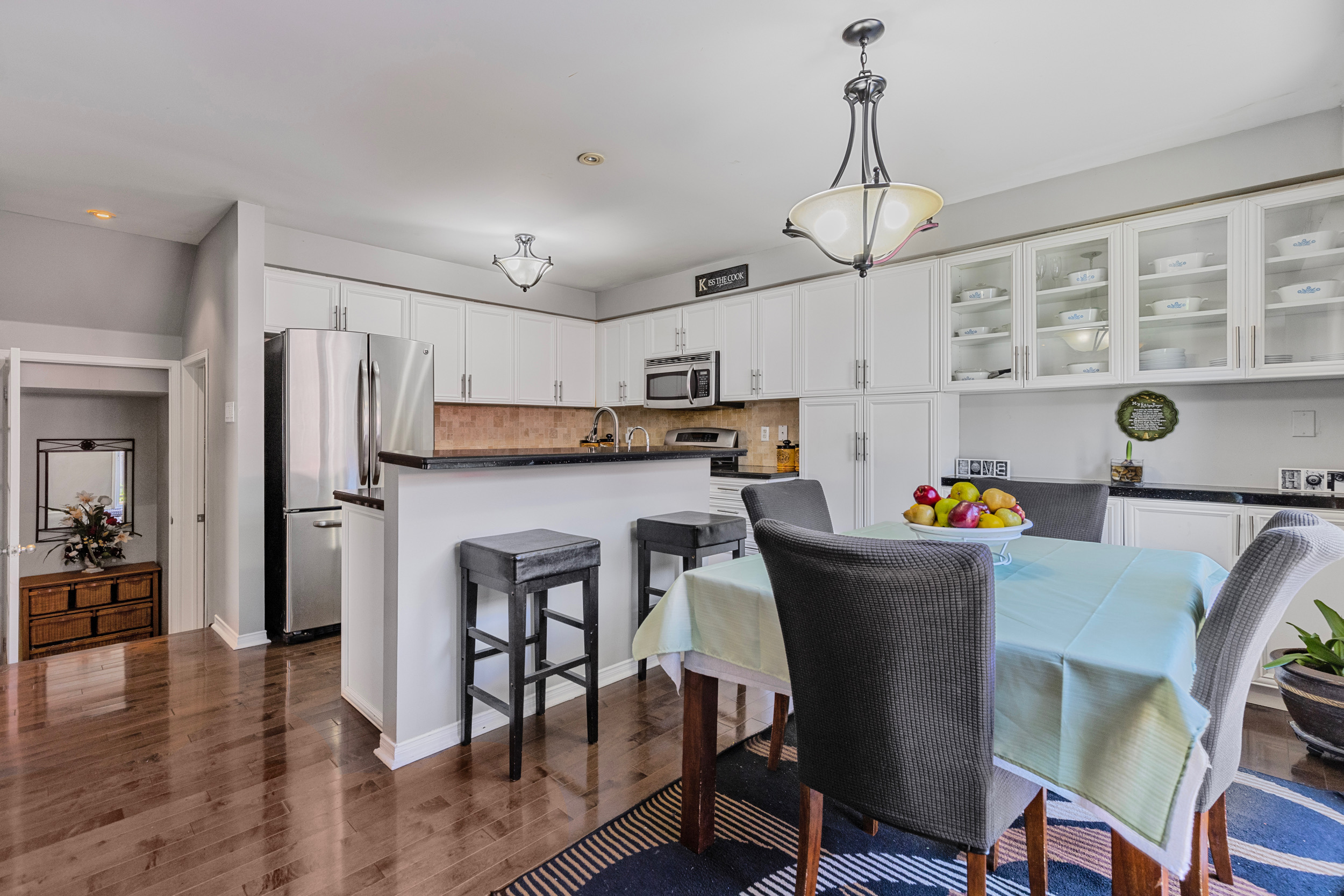 Kitchen eat-in area with dining table and white cabinets