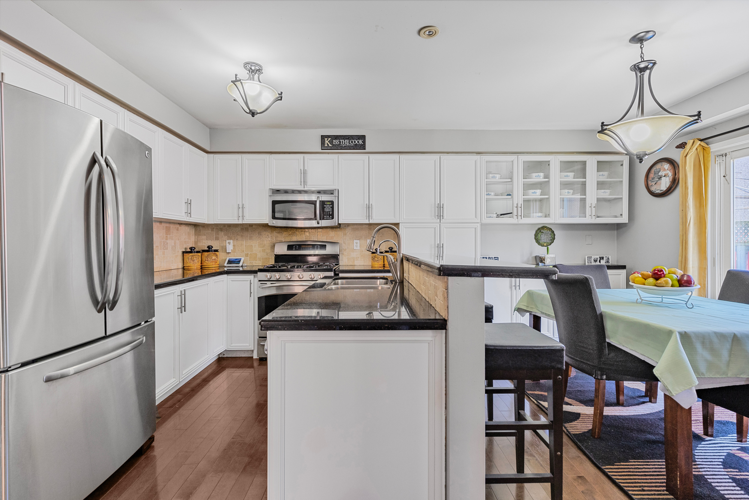 Kitchen with white cabinets and adjoining dining area