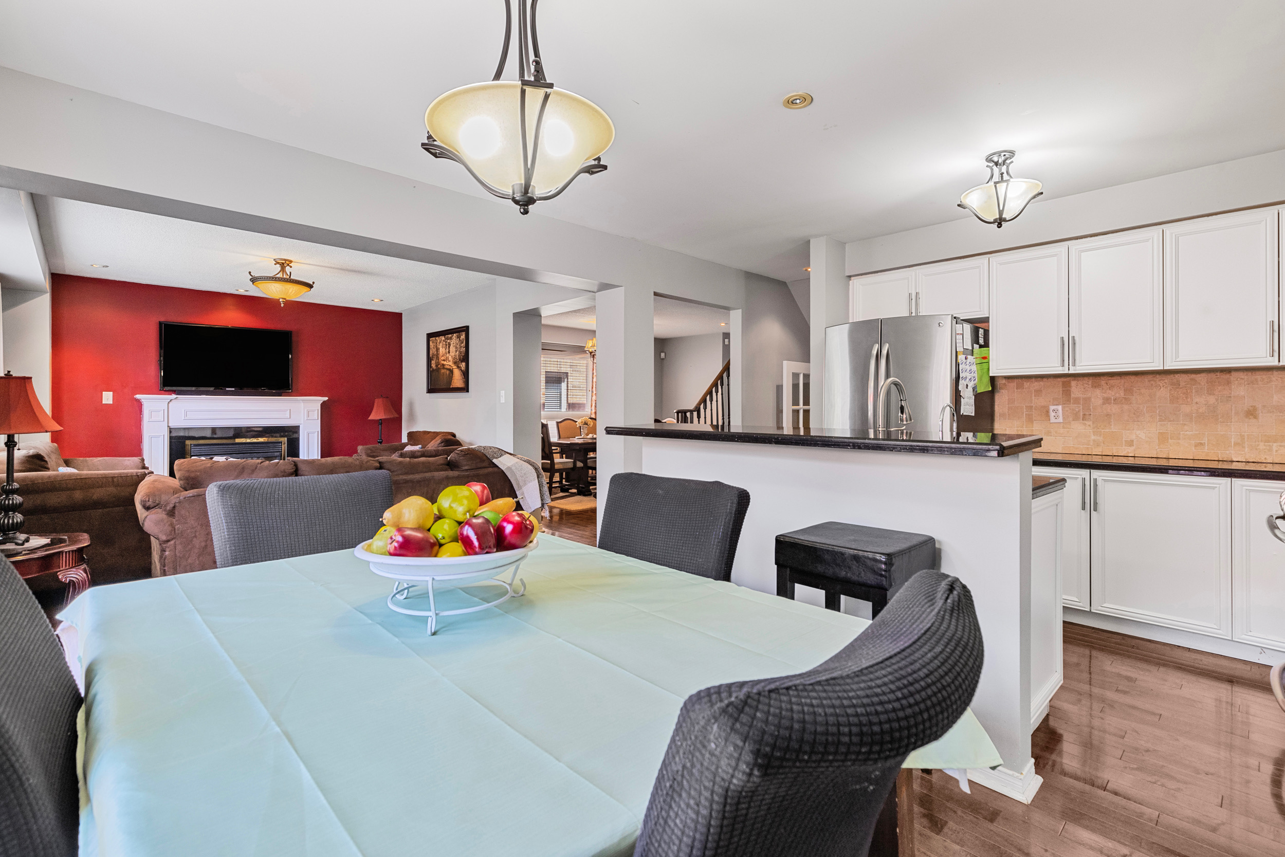 Kitchen and dining open concept with red accent wall in living room