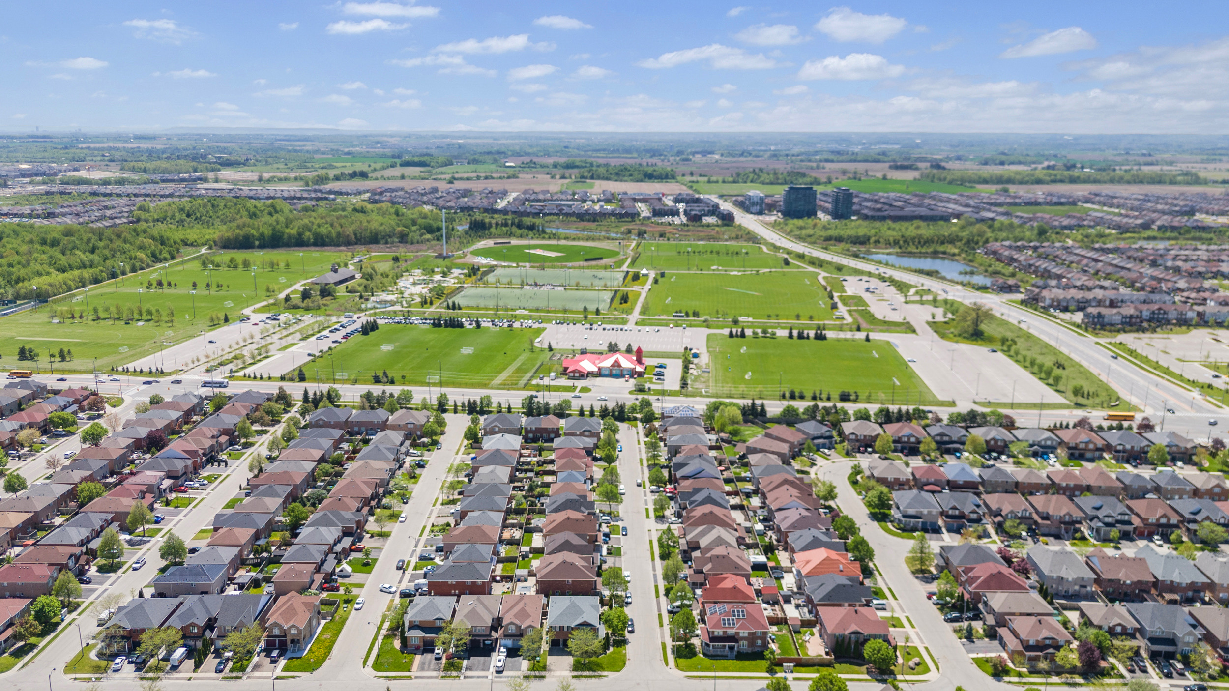 Aerial view of residential development adjacent to parks and green space
