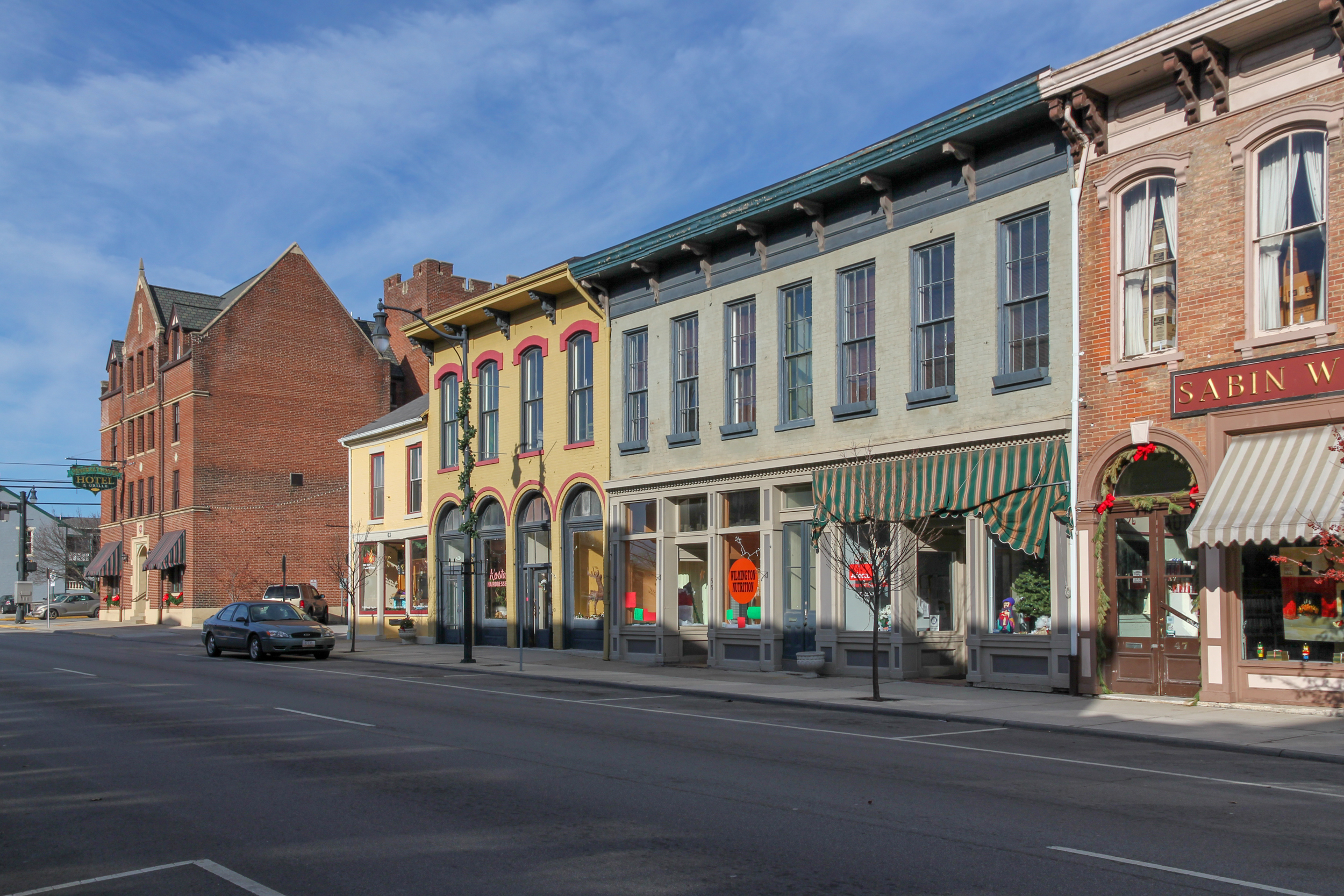 Historic downtown Wilmington, Ohio commercial buildings along a tree-lined street