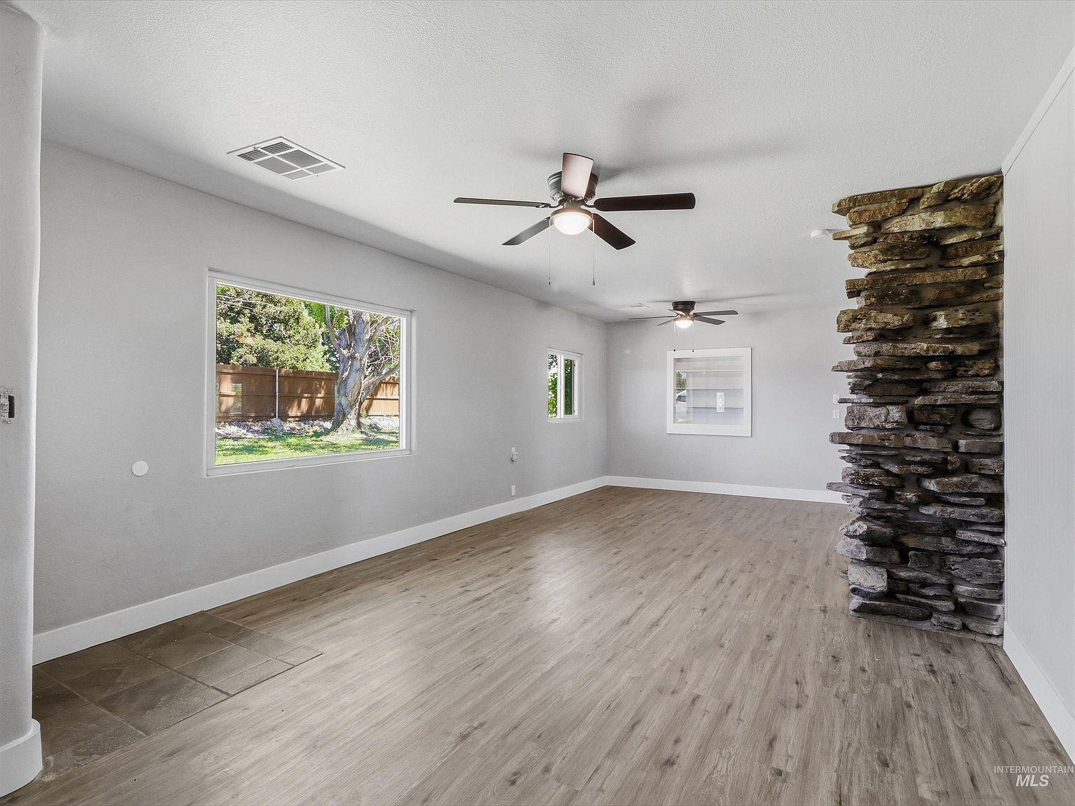Living room with floor-to-ceiling stacked stone fireplace
