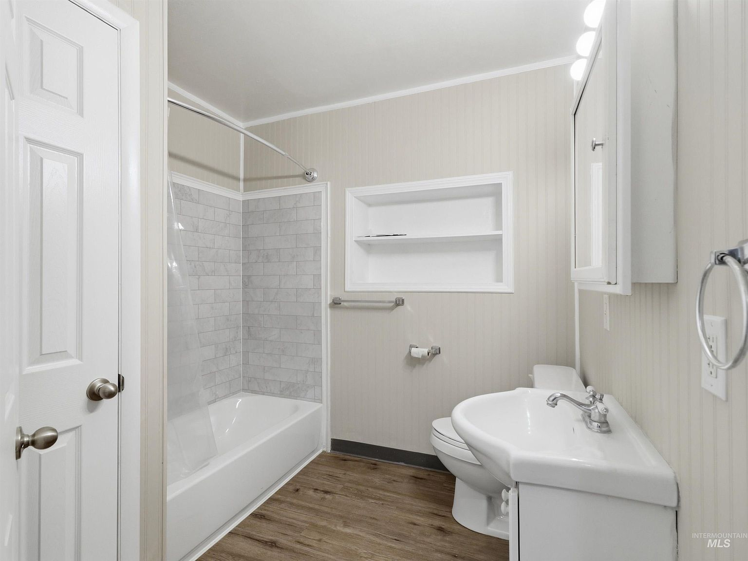 Updated bathroom with pedestal sink and subway tile surround