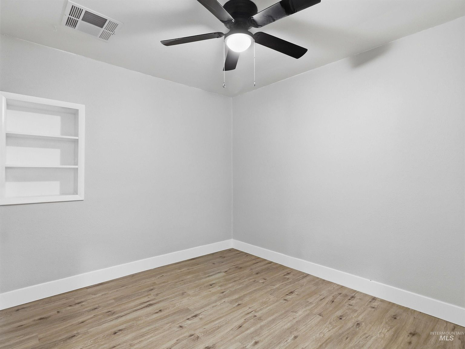 Bedroom with built-in wall niche shelving