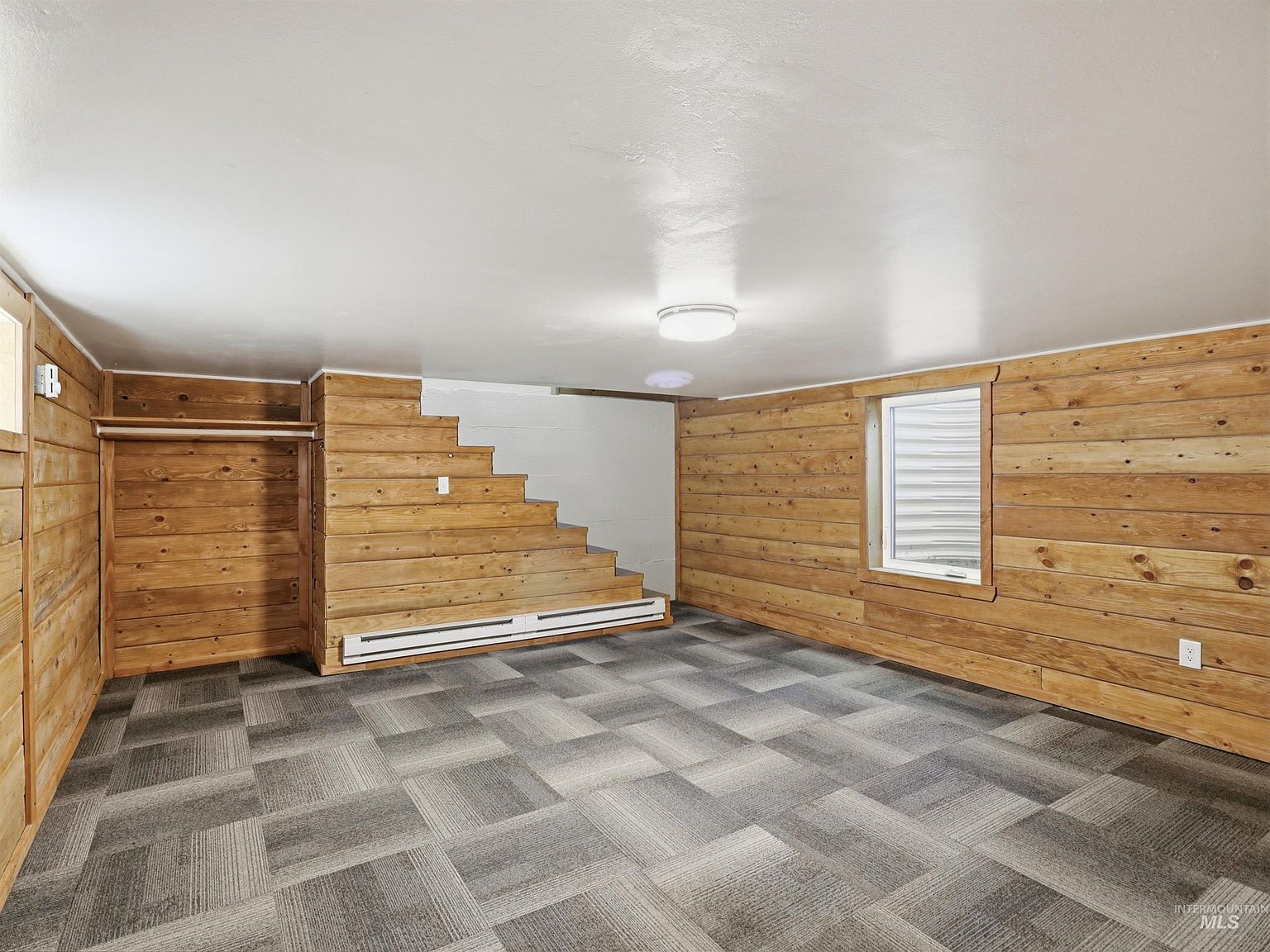 Lower level bedroom with rustic wood plank walls