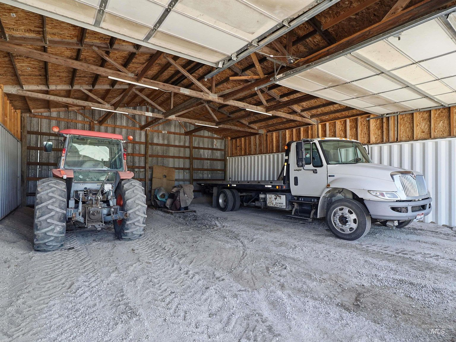 Second shop interior with open bay door and storage space