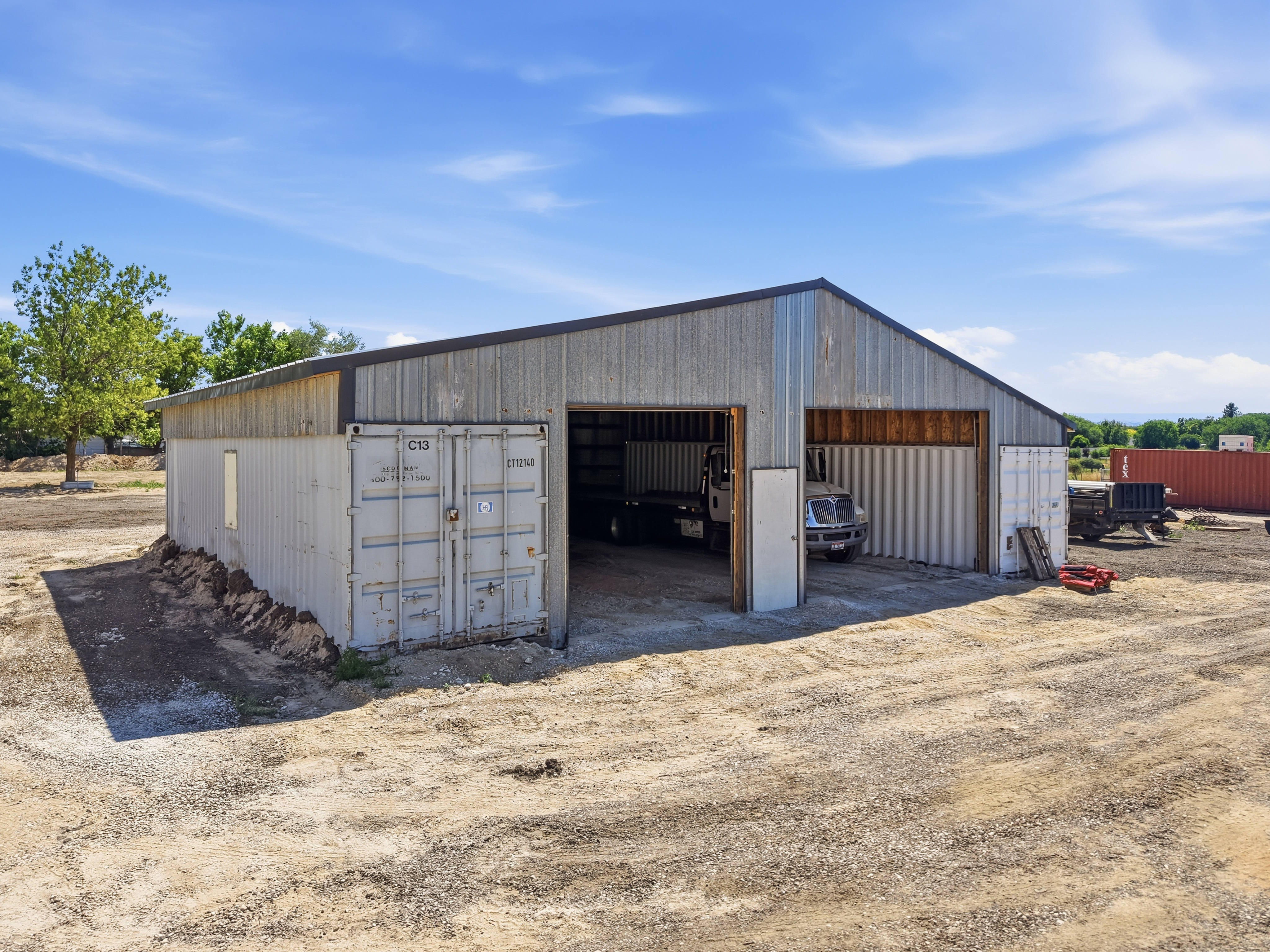 Exterior of second large workshop building with corrugated metal siding