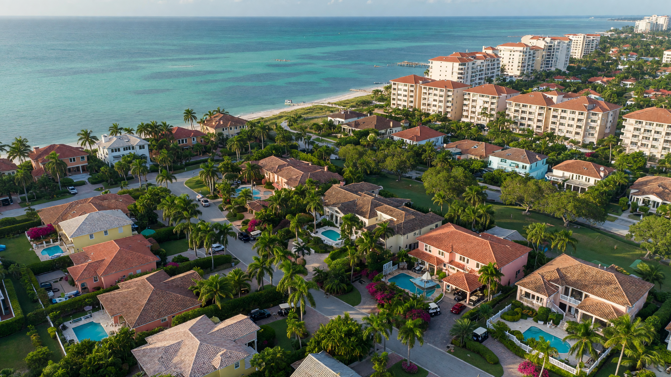 Luxury estate home with paver driveway and manicured landscaping in The Moorings, Naples