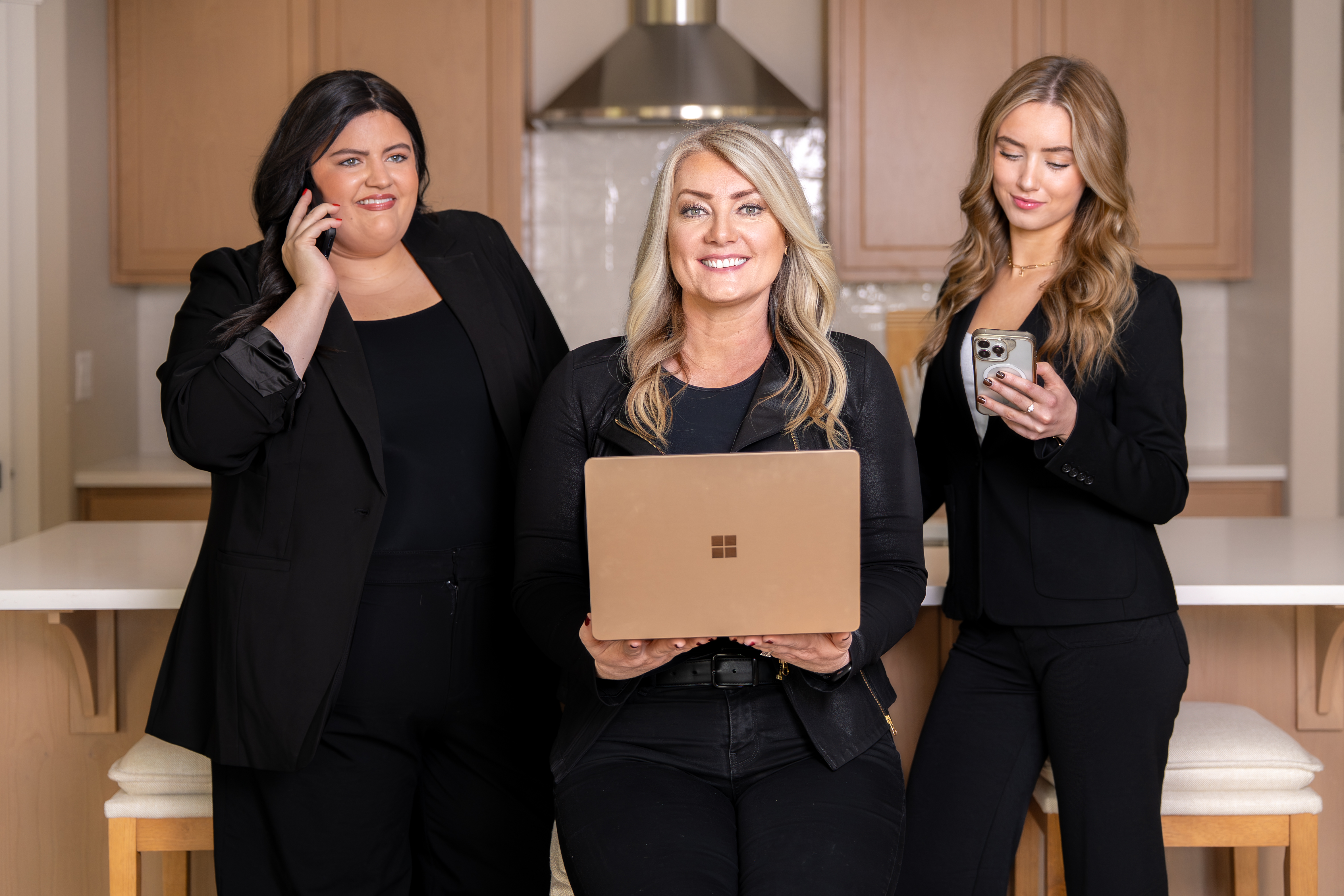 The Davis Real Estate team — Richelle Davis, Hannah Turner, and Holly Gale working together in a modern kitchen