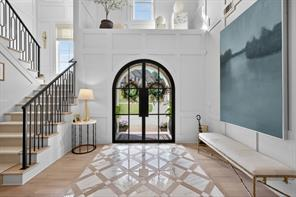 Grand entryway staircase with custom finishes