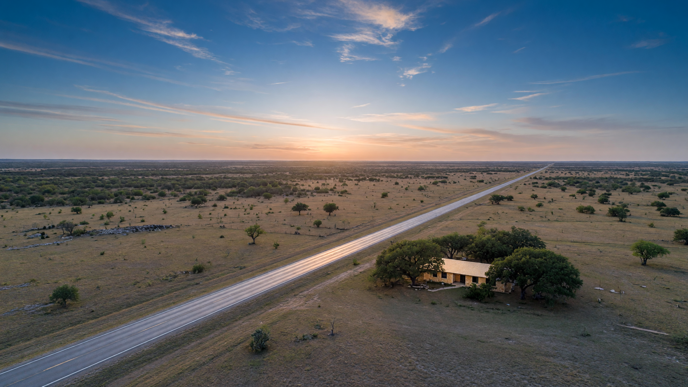 A long straight road stretching across the flat Texas landscape toward a distant Hill Country home, evoking the distance and challenge of managing property from another state