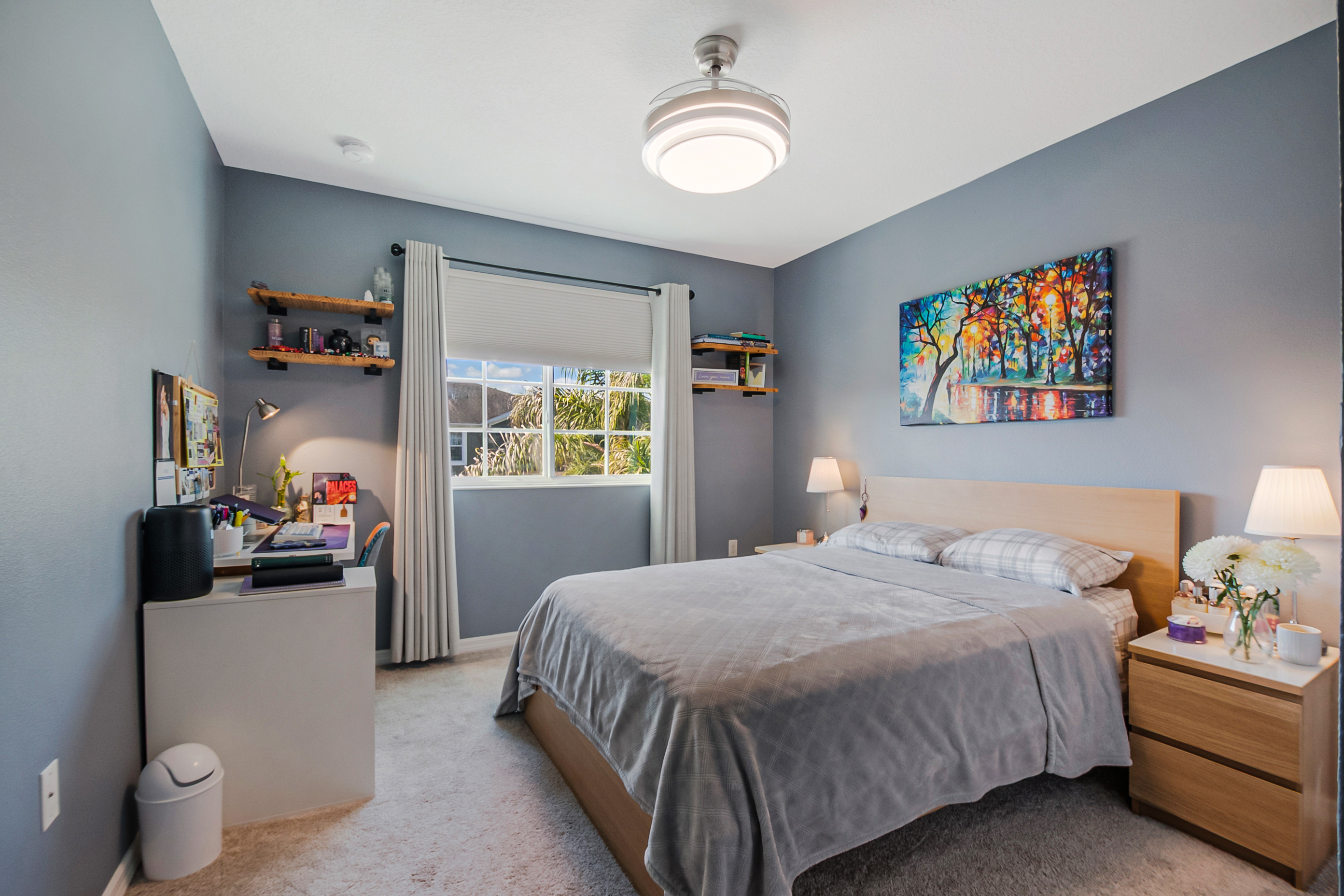 Secondary bedroom with grey-blue walls and light wood bed frame
