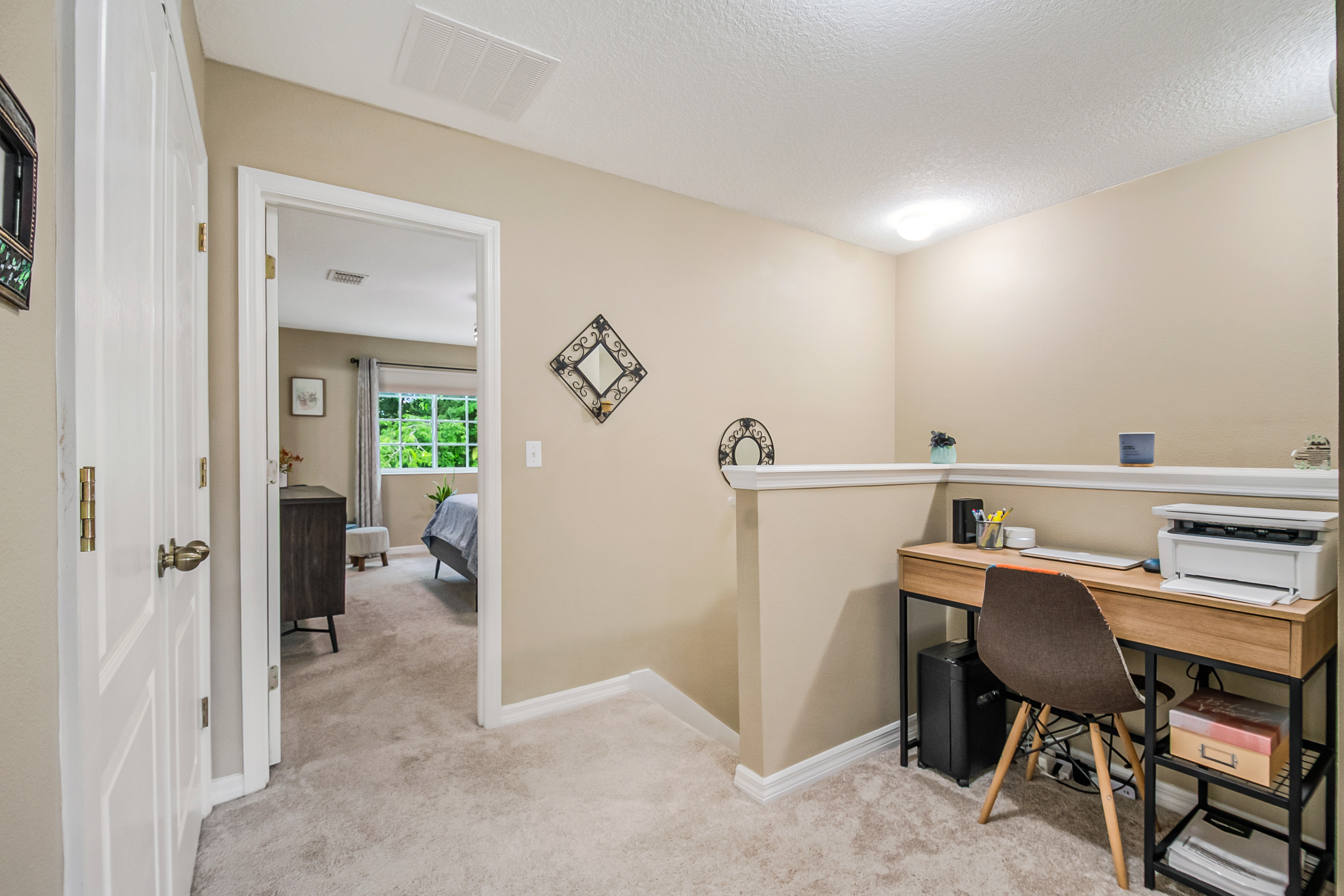 Upper-level landing with home office setup and natural light