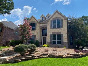 Two-story brick facade exterior of 6106 Peachtree Hill Court in Kingwood, Texas