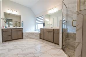 Primary bathroom double vanity at 16903 Lupine Meadow Lane in The Groves, Humble, Texas