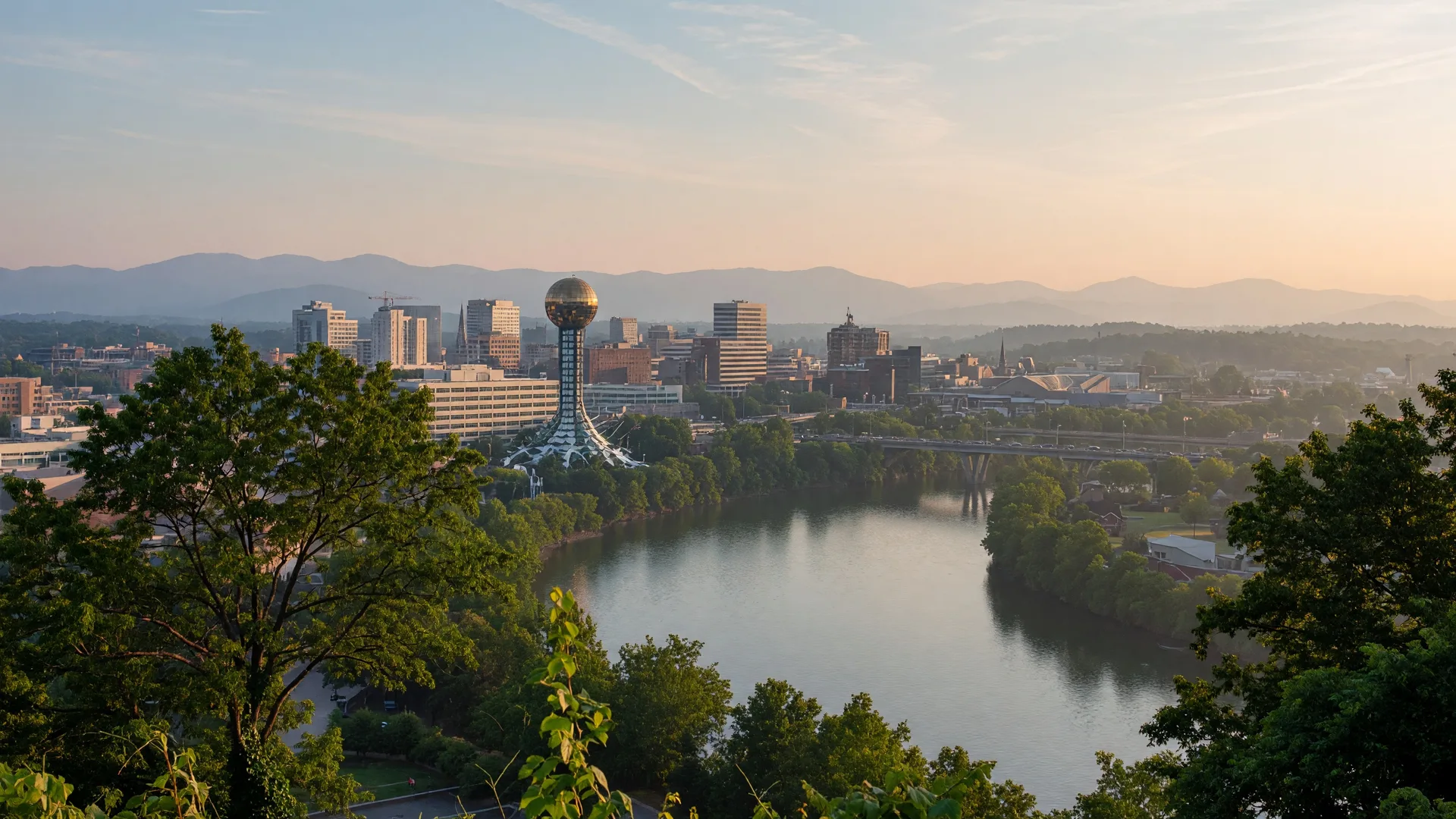 Scenic aerial view of Knoxville with the Tennessee River and Smoky Mountains in the distance