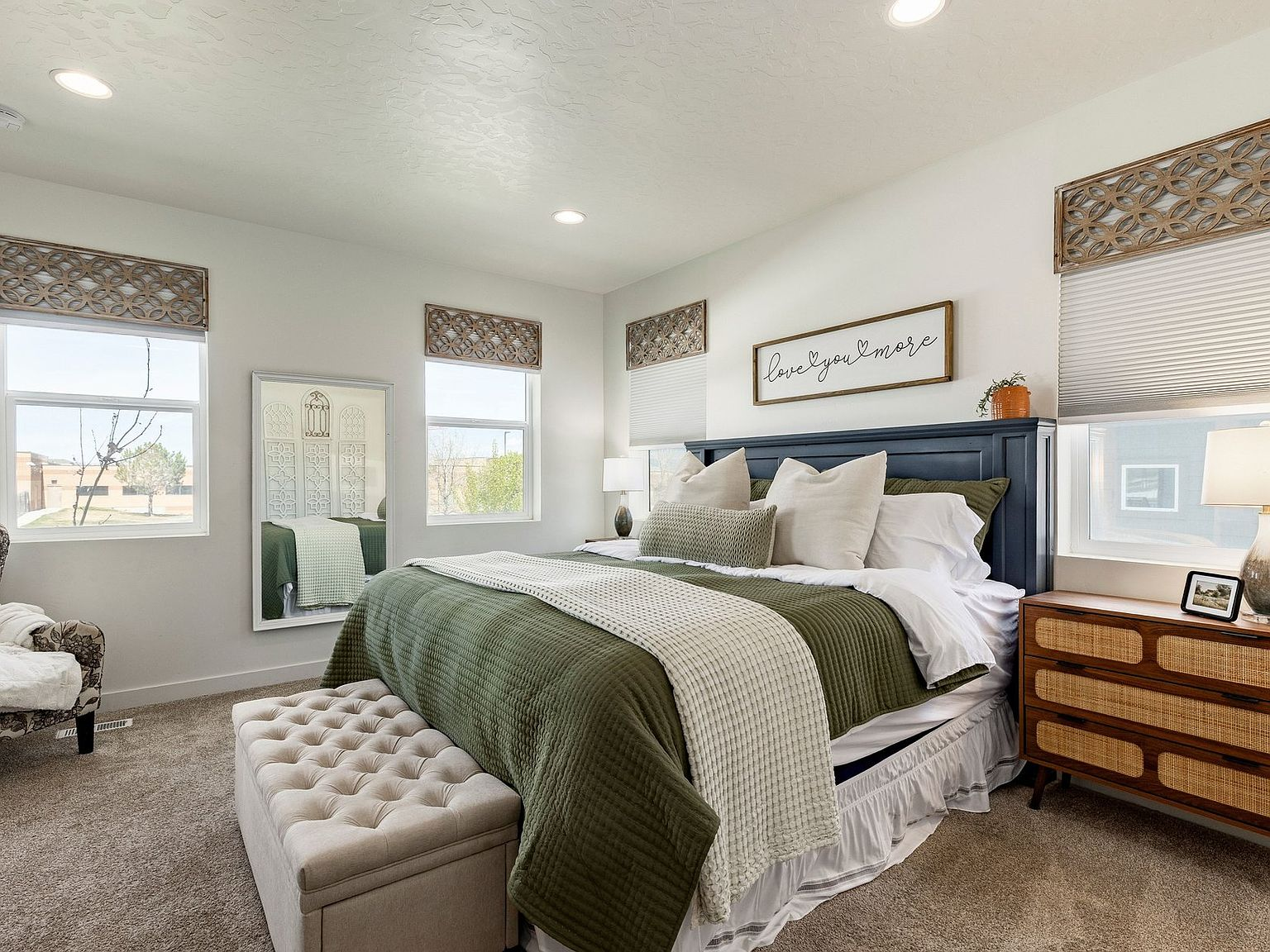 The primary bedroom, bright and calm with morning light