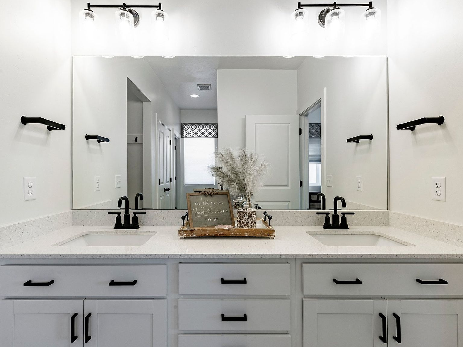 Bathroom with double vanity and black hardware