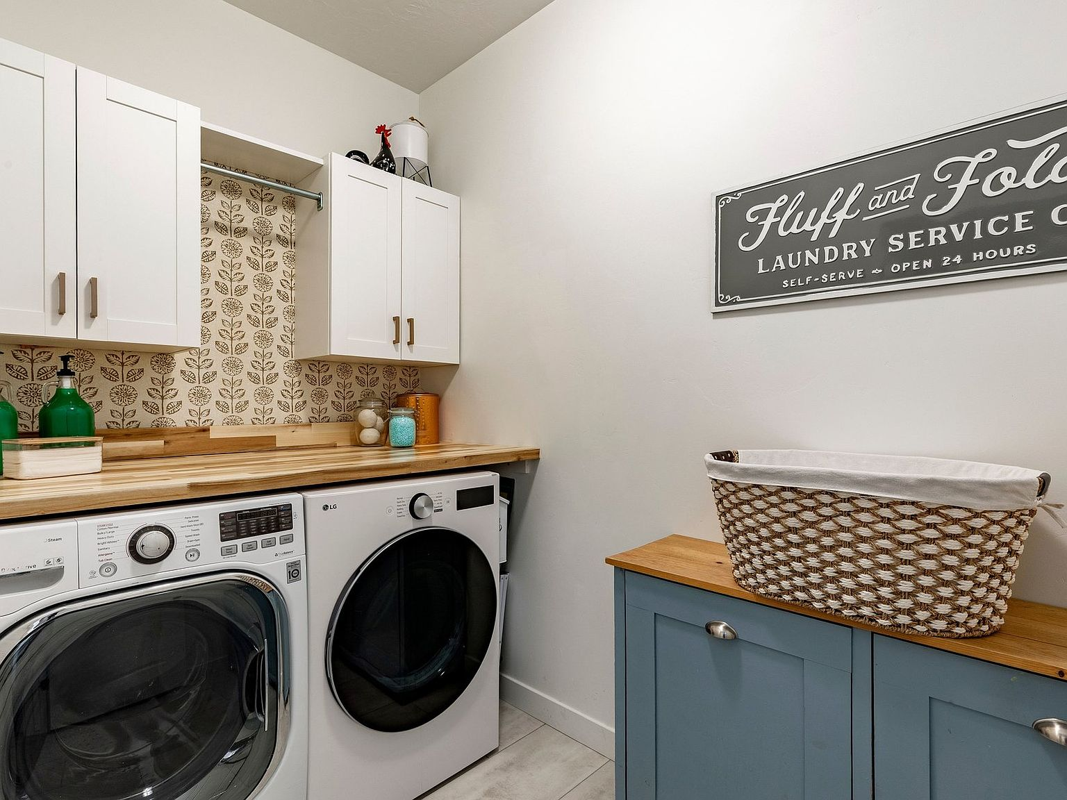 Modern laundry room with floral wallpaper accent
