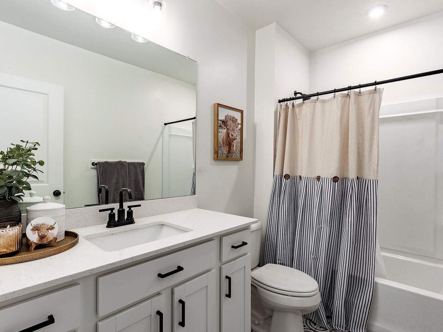 Modern bathroom with white vanity and black fixtures