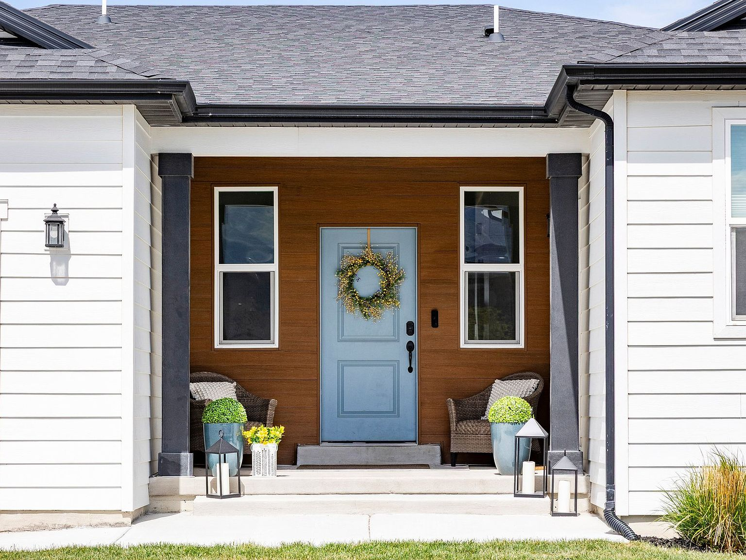 Front entry porch with blue door and wood accent wall