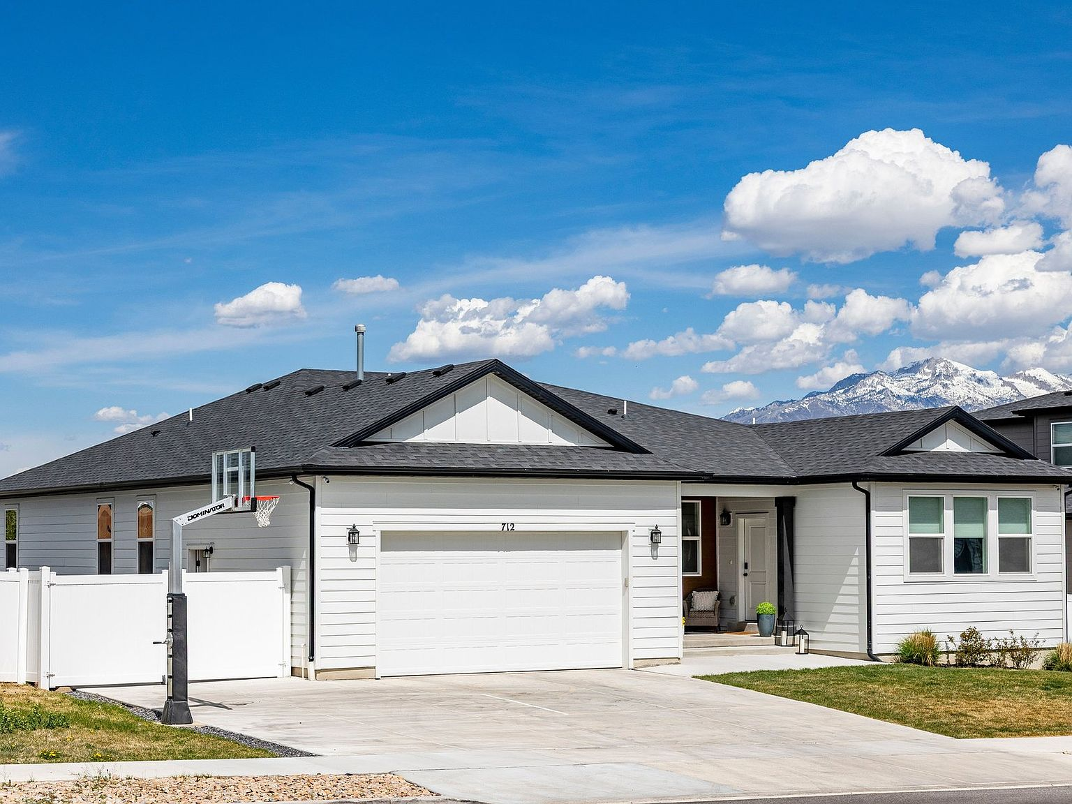 Full exterior view with driveway and mountain backdrop
