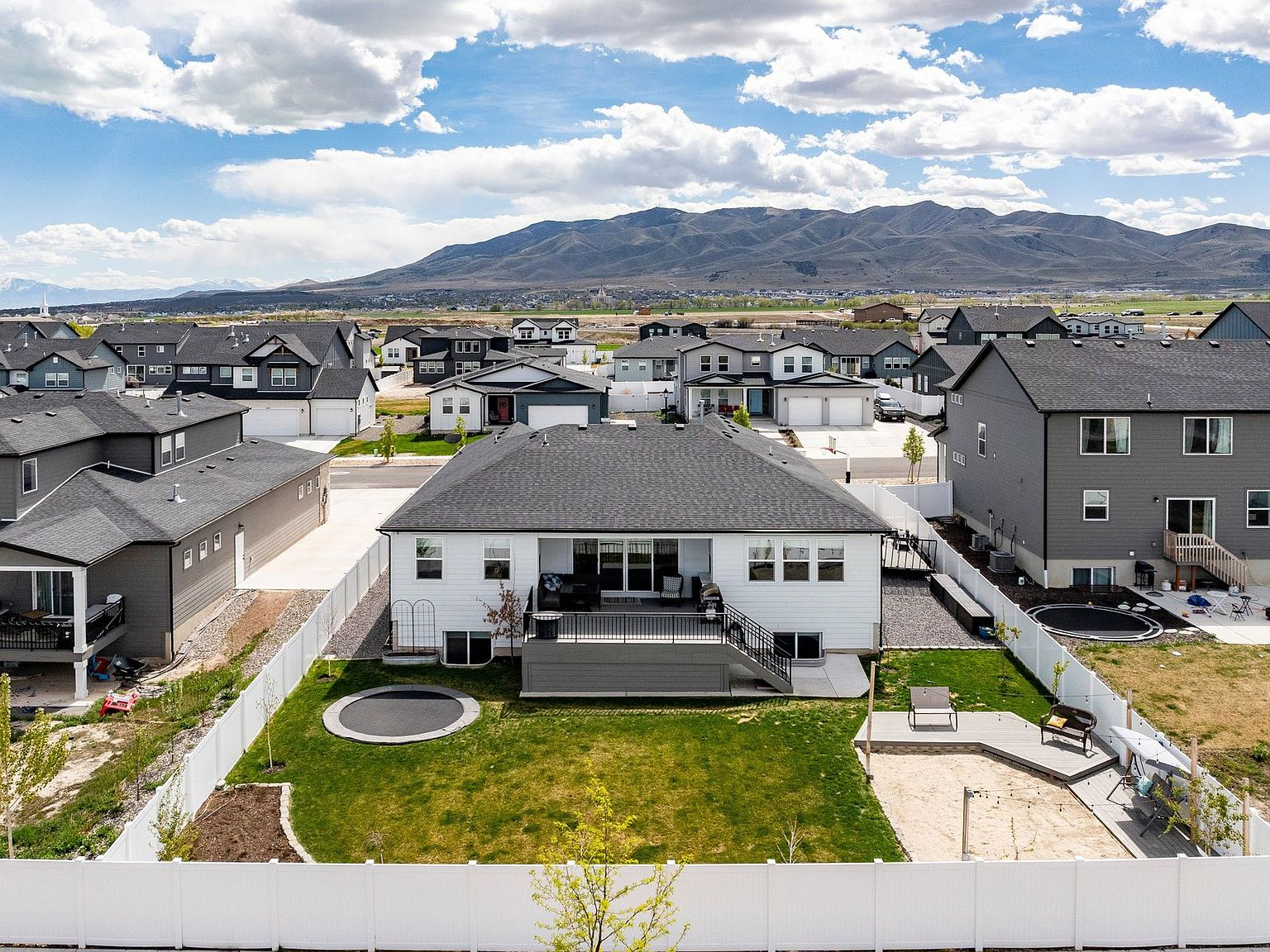 Aerial view of the backyard, deck, and trampoline