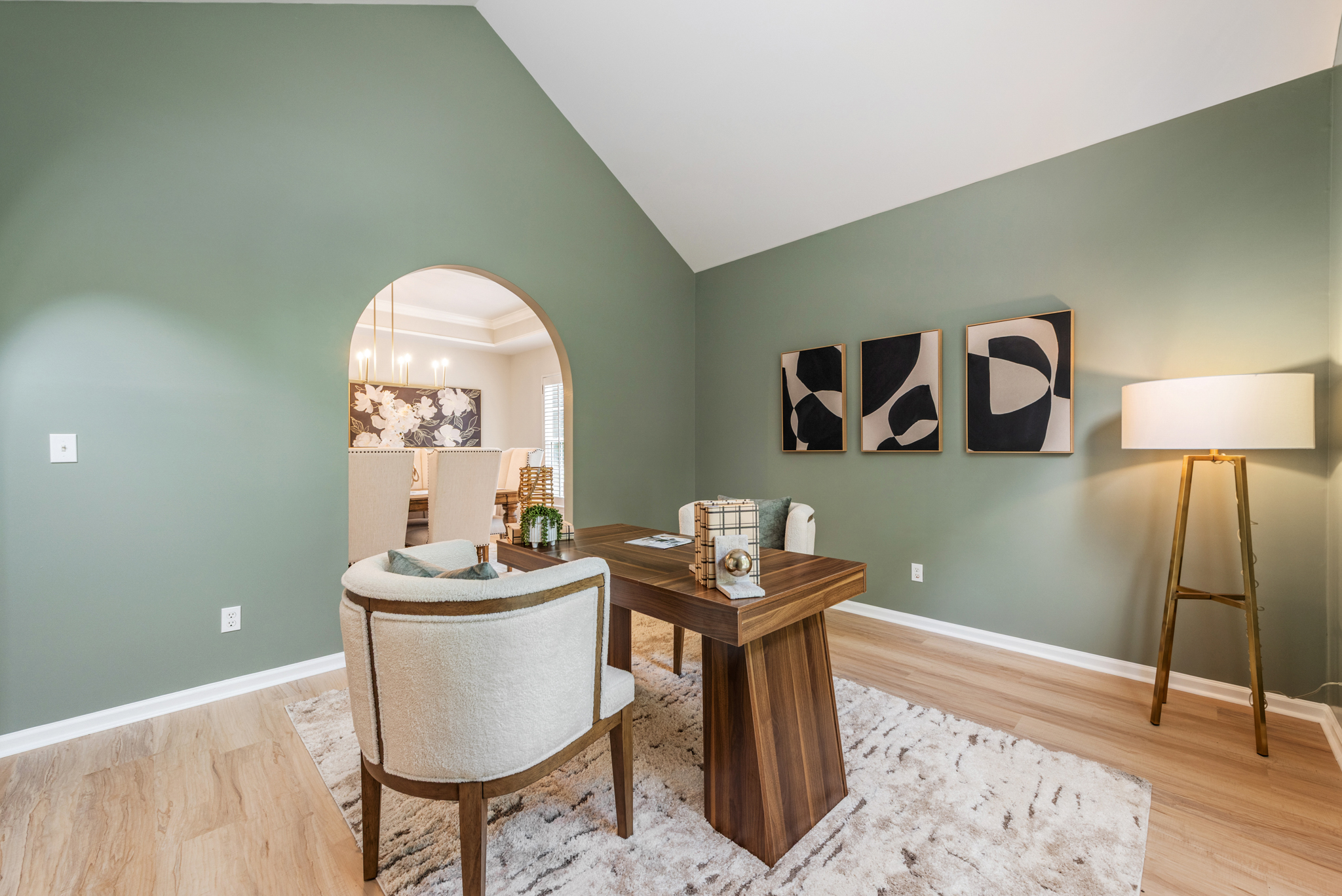 Home office with arched entry and vaulted ceiling in transitional style